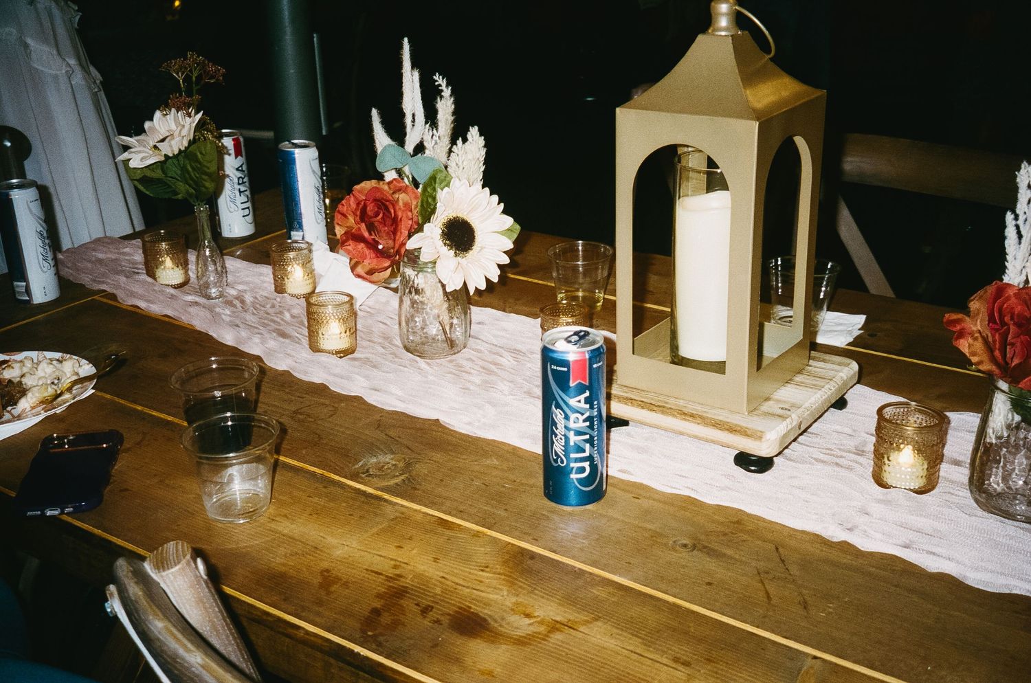 Close-up of wooden tables with drinks and decorative elements.