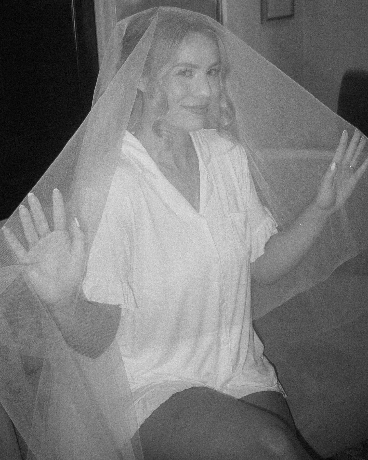A series of black and white photos showing someone in a white sheet pose in different playful ghost-like positions.