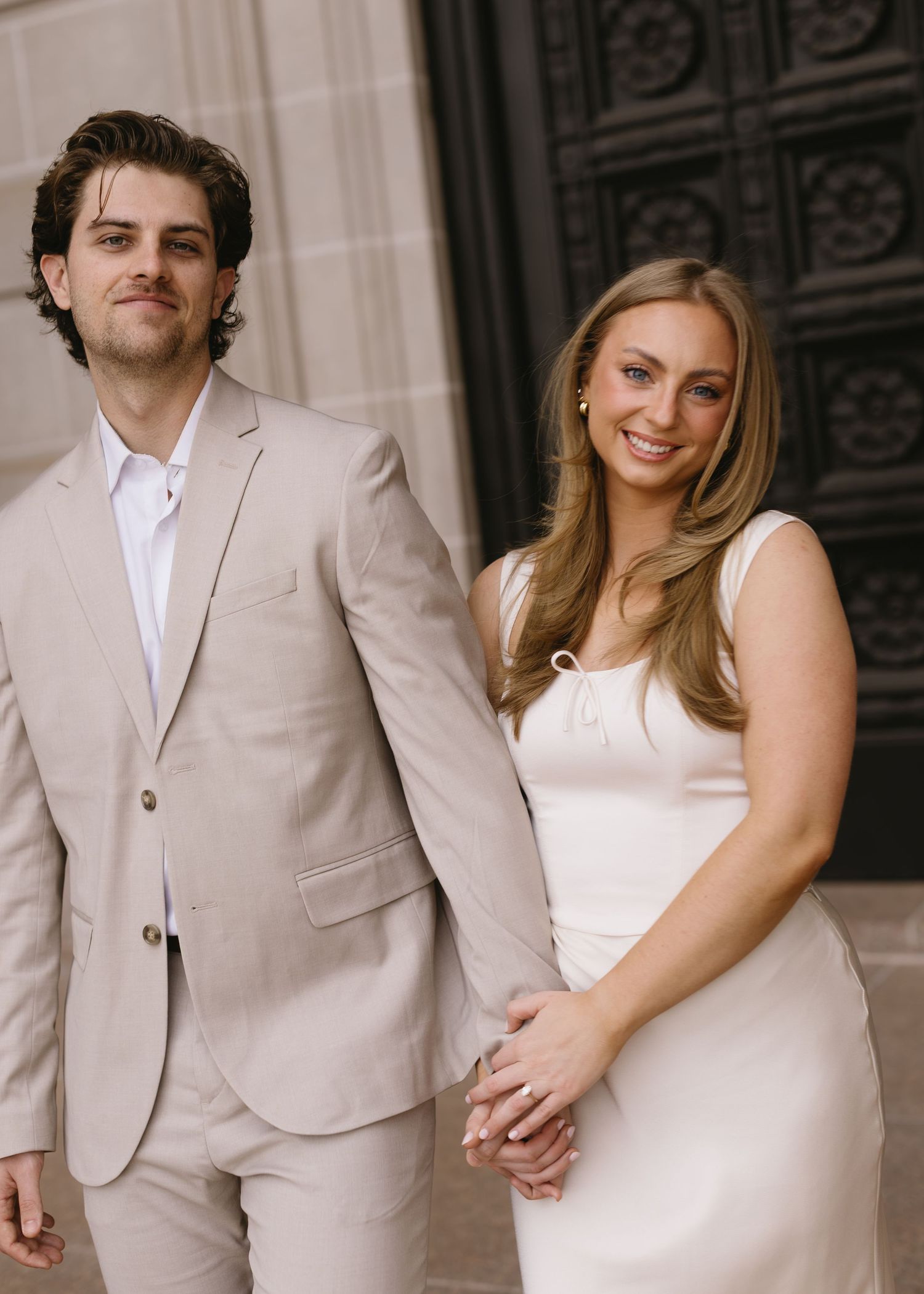 A series of romantic poses showing a couple in beige and white formal wear against a classical backdrop.