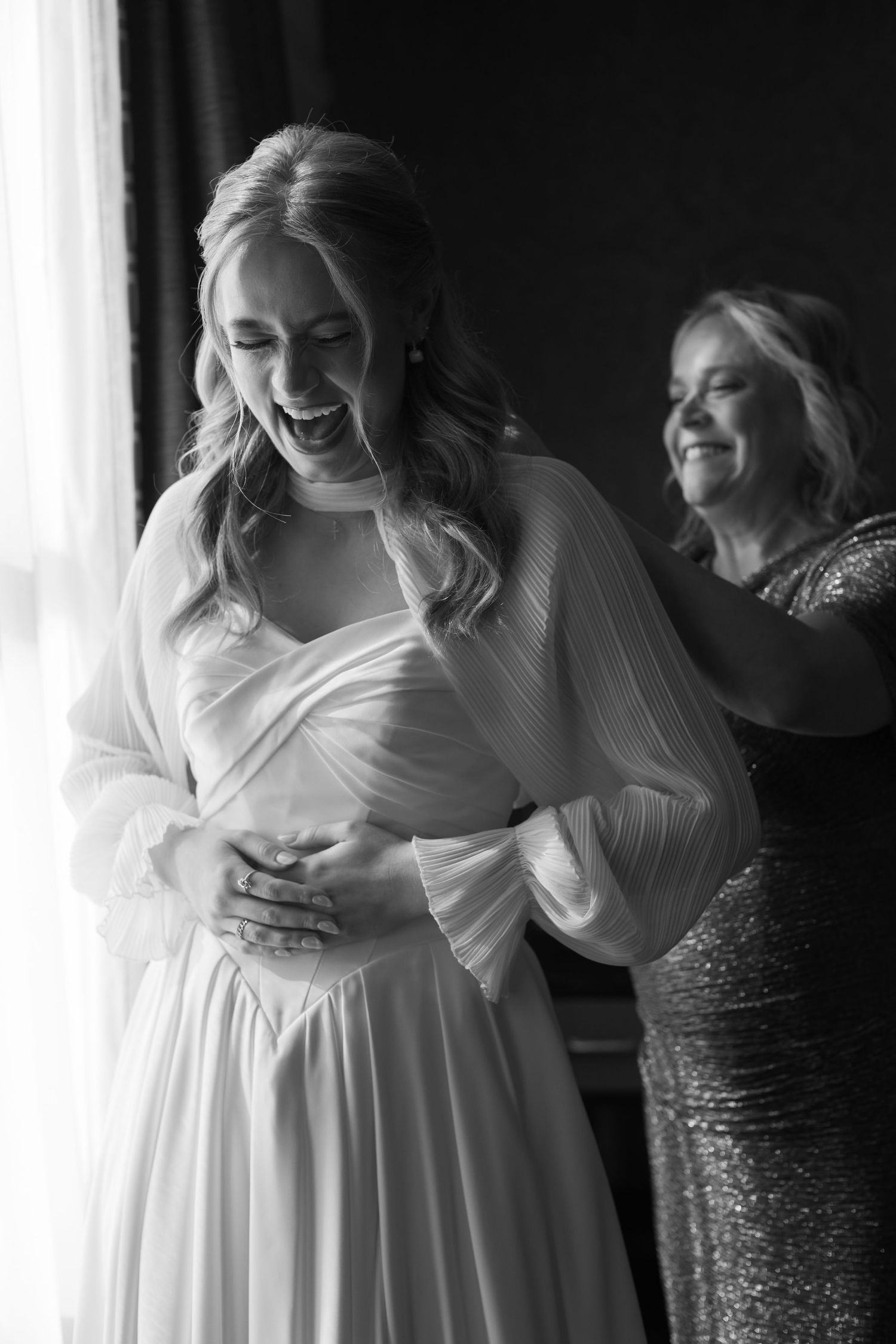 Natural candid moments shared during wedding day preparations in black and white.