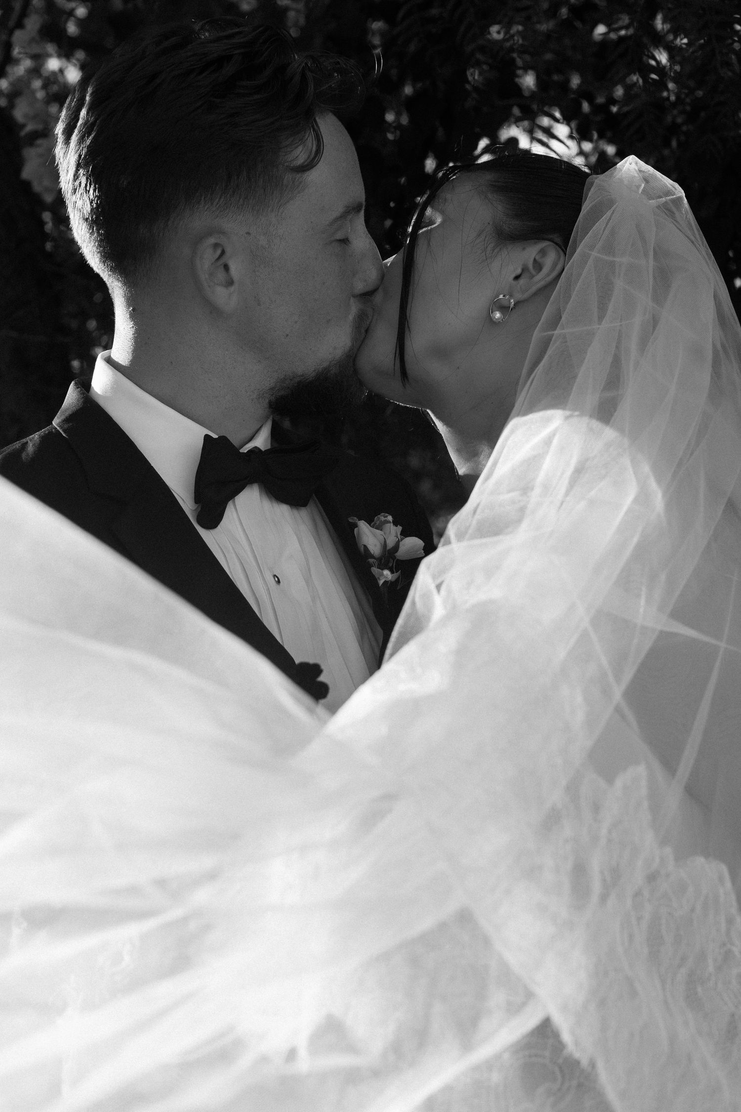 Black and white intimate wedding portraits showing tender moments between newlyweds.