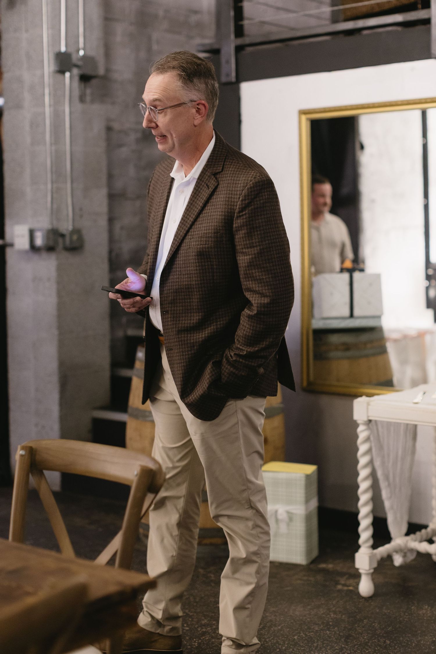 Candid moments captured at an indoor venue with exposed brick walls and elegant lighting.