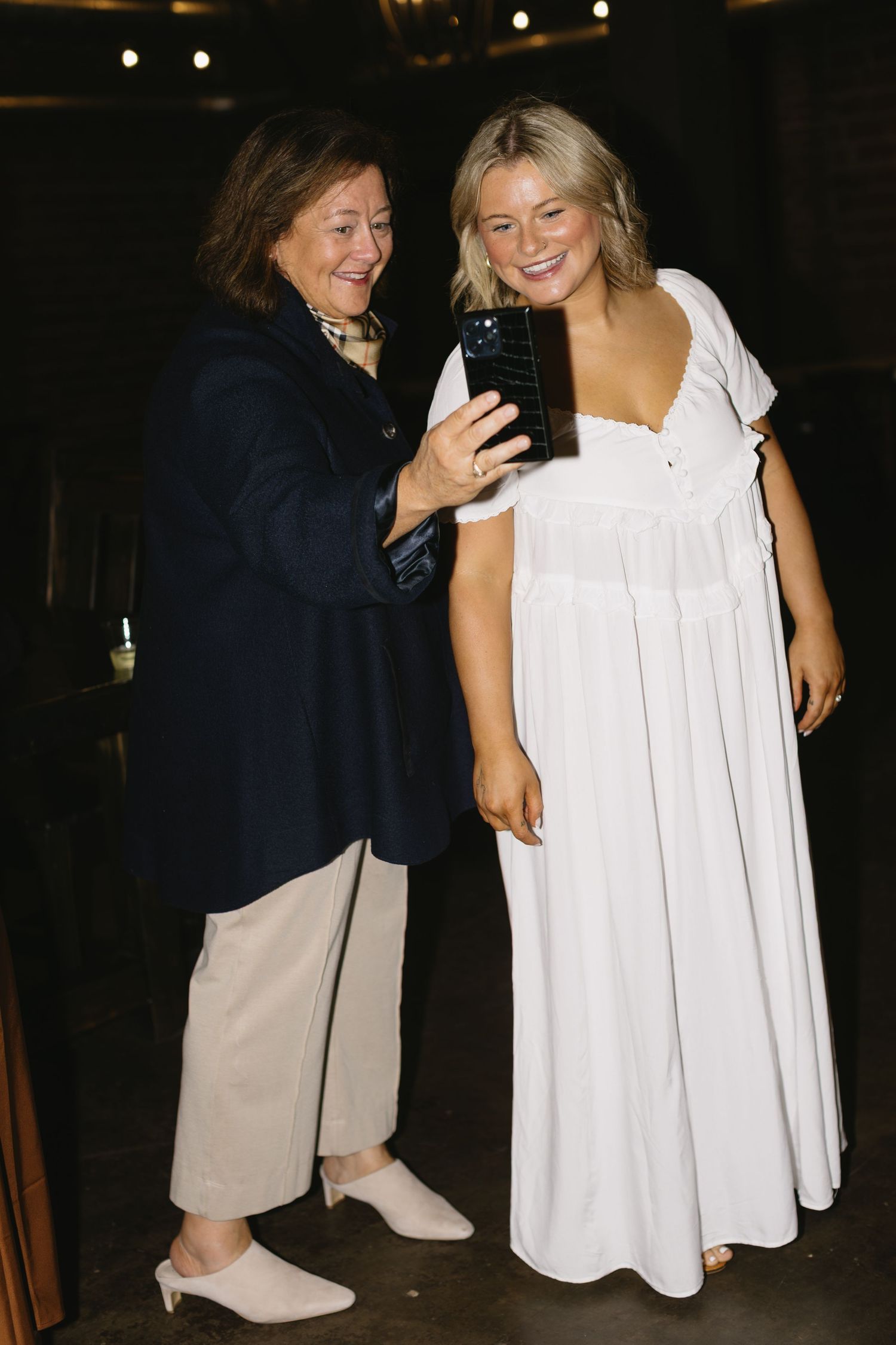 Candid moment of wedding guests dancing and celebrating at an evening reception.