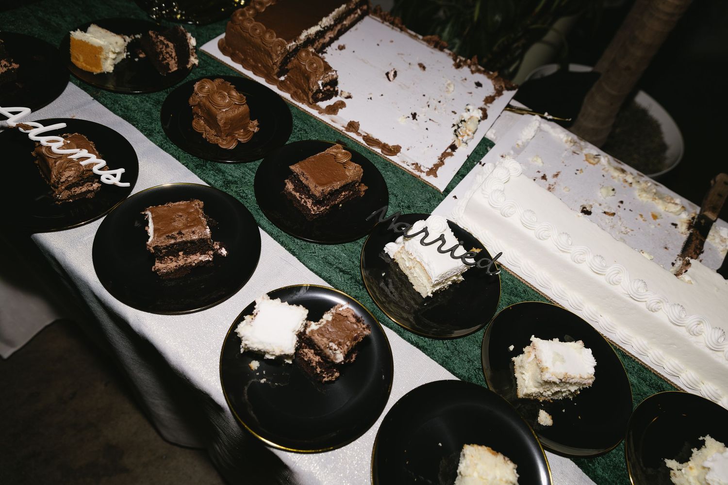 Dessert plates with chocolate brownies and cake slices at a wedding reception.