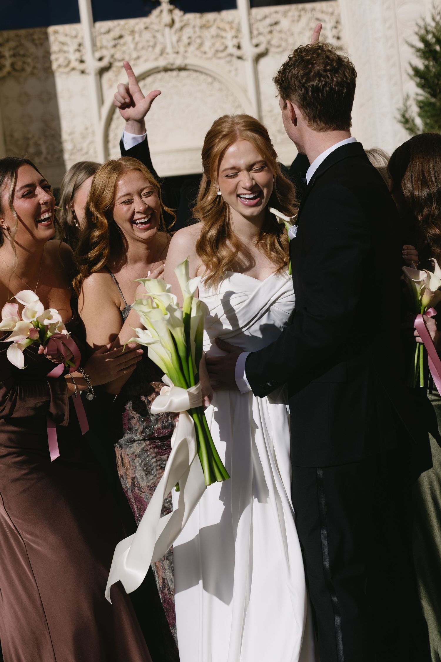 Joyful outdoor wedding party photos with bridesmaids in brown dresses and white calla lilies.