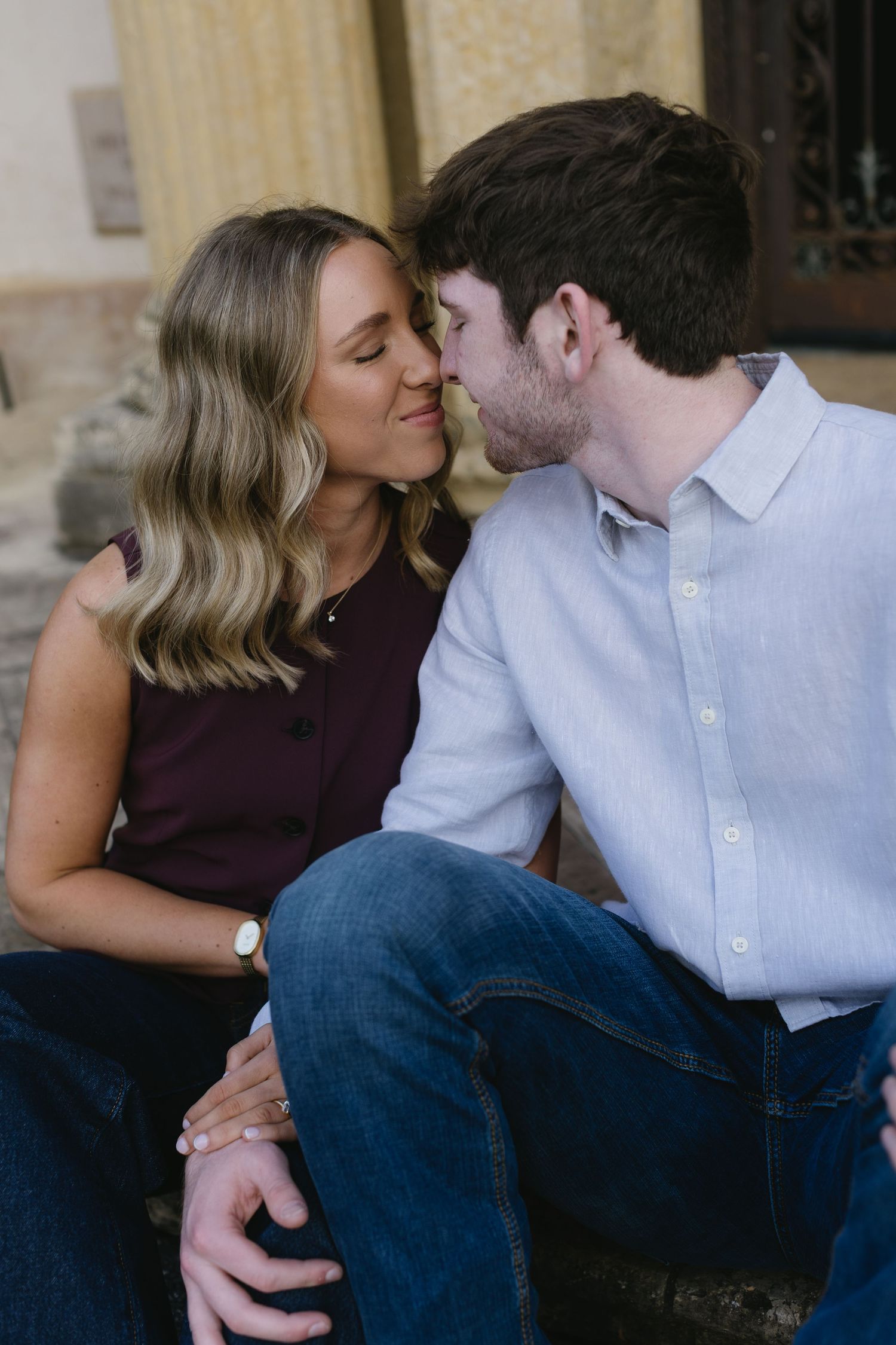 A romantic couple shares intimate moments in a series of candid poses while wearing casual attire.