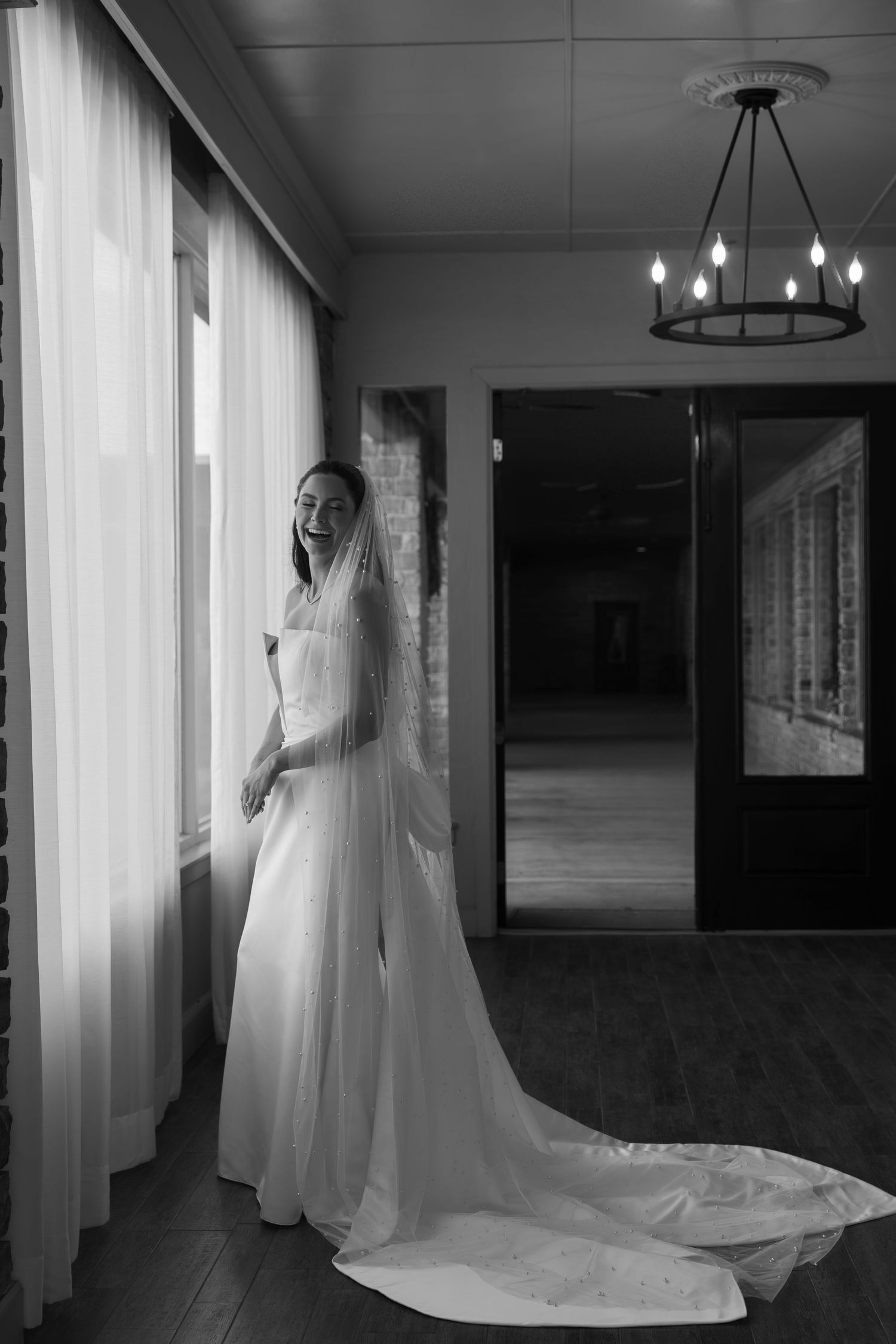 Wedding dress with dramatic train photographed in an elegant indoor venue.