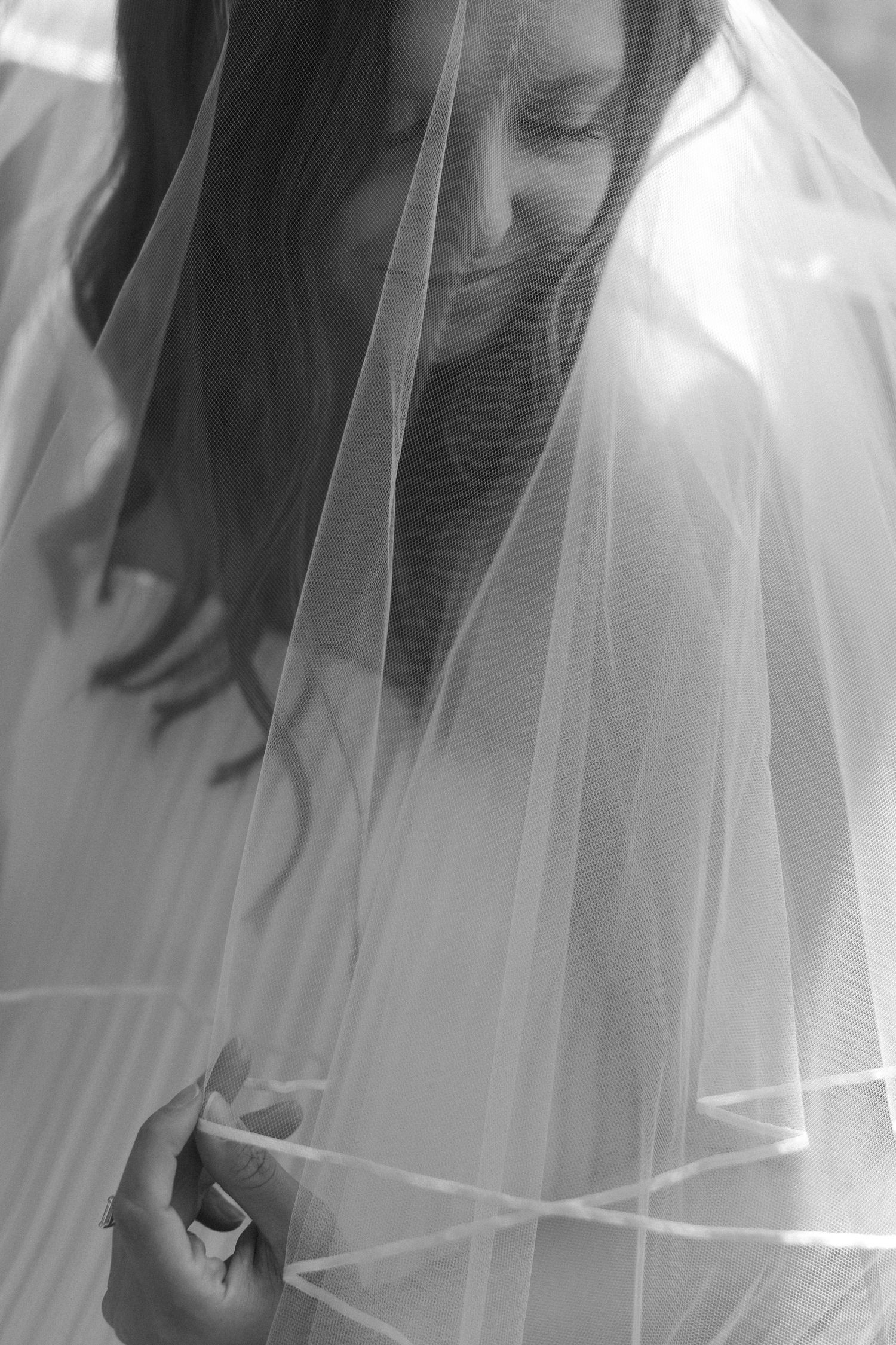 Artistic black and white close-up of bridal veil details.