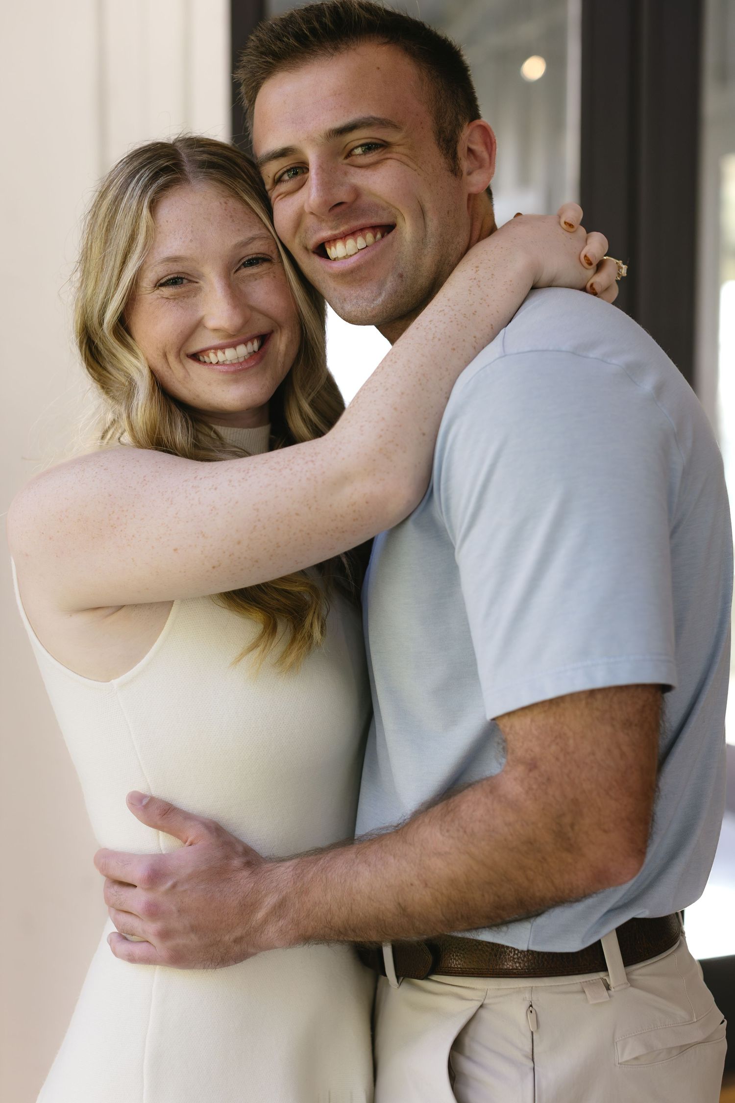 A series of romantic couple portraits showing intimate embraces in casual attire against a light background.