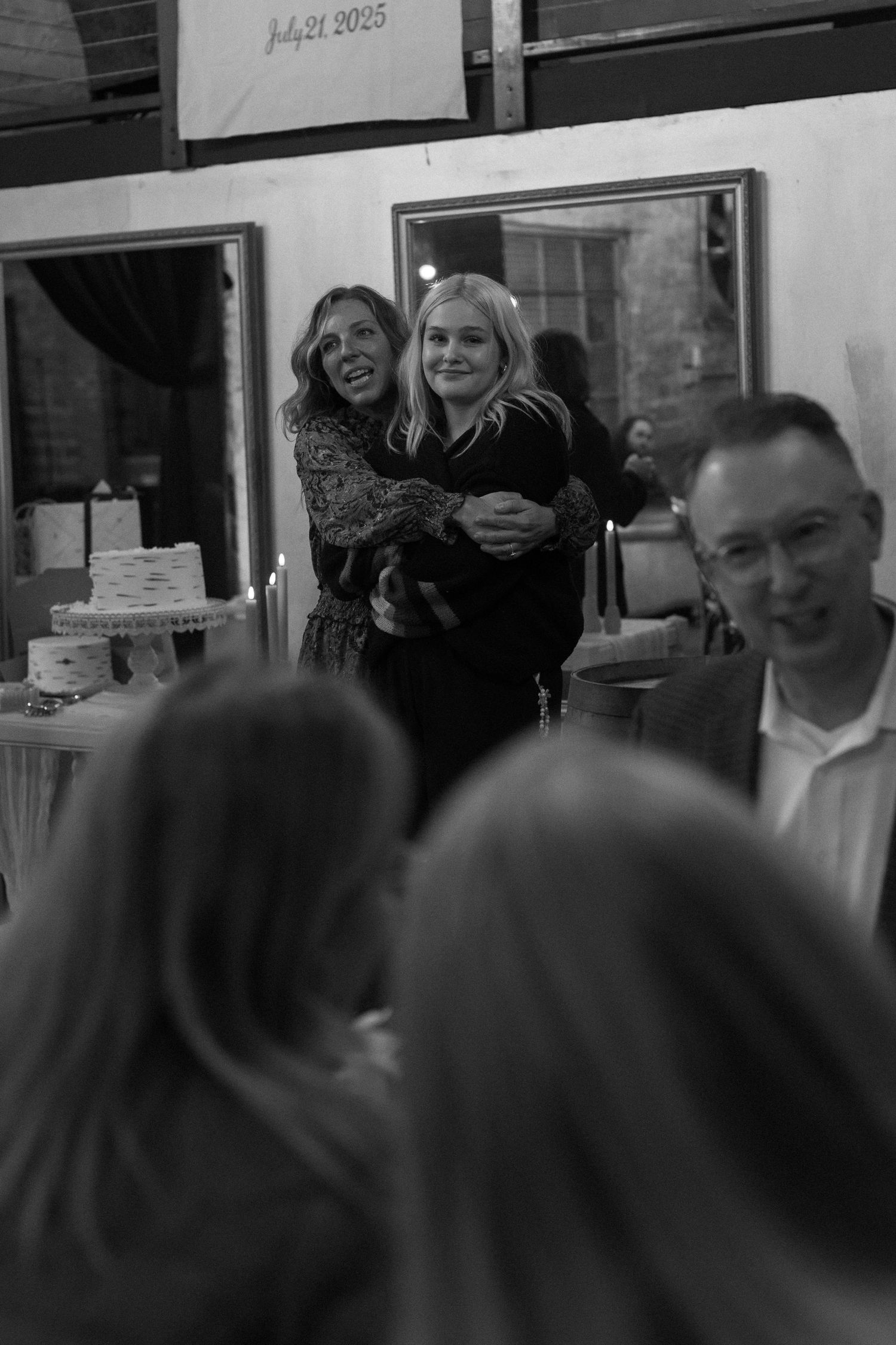 People celebrating and socializing at an indoor event space with bright lighting.