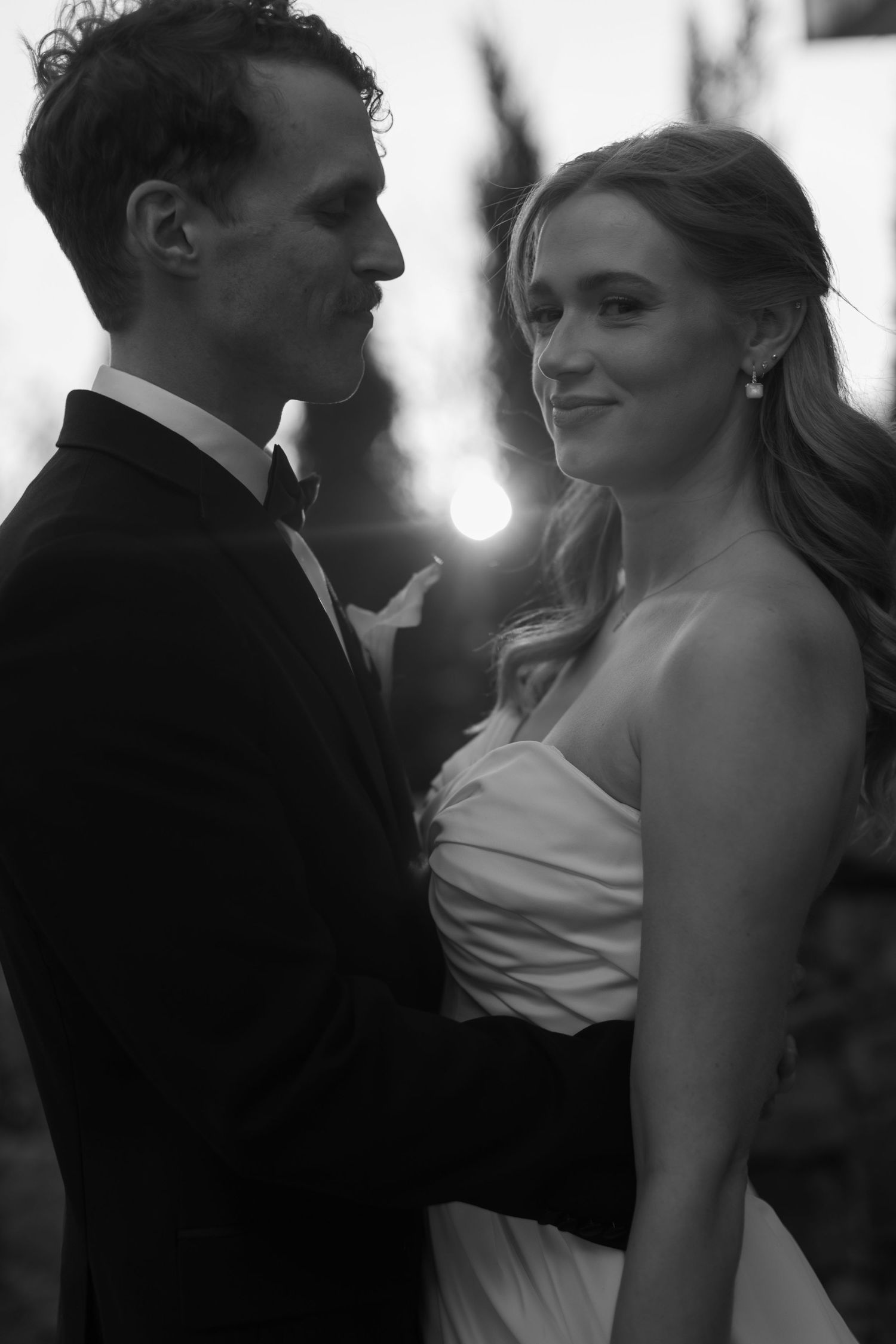 Intimate black and white portrait of newlyweds sharing a romantic moment.