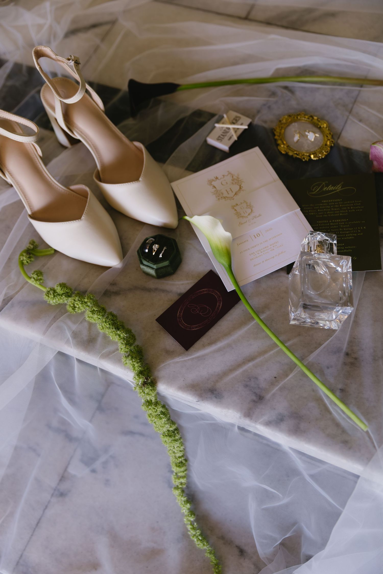 Wedding accessories including high heels, jewelry, and decorative elements styled on light fabric.