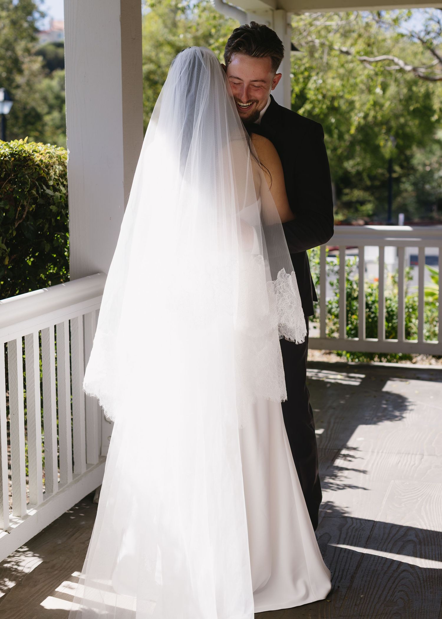 A sequence of wedding photos capturing a couple's intimate moments on a white porch with sunlight.