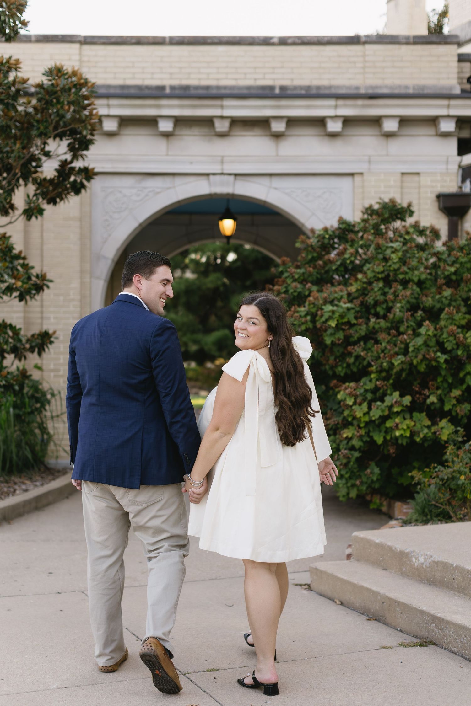 A playful sequence of a couple dancing and posing together on a stone patio.