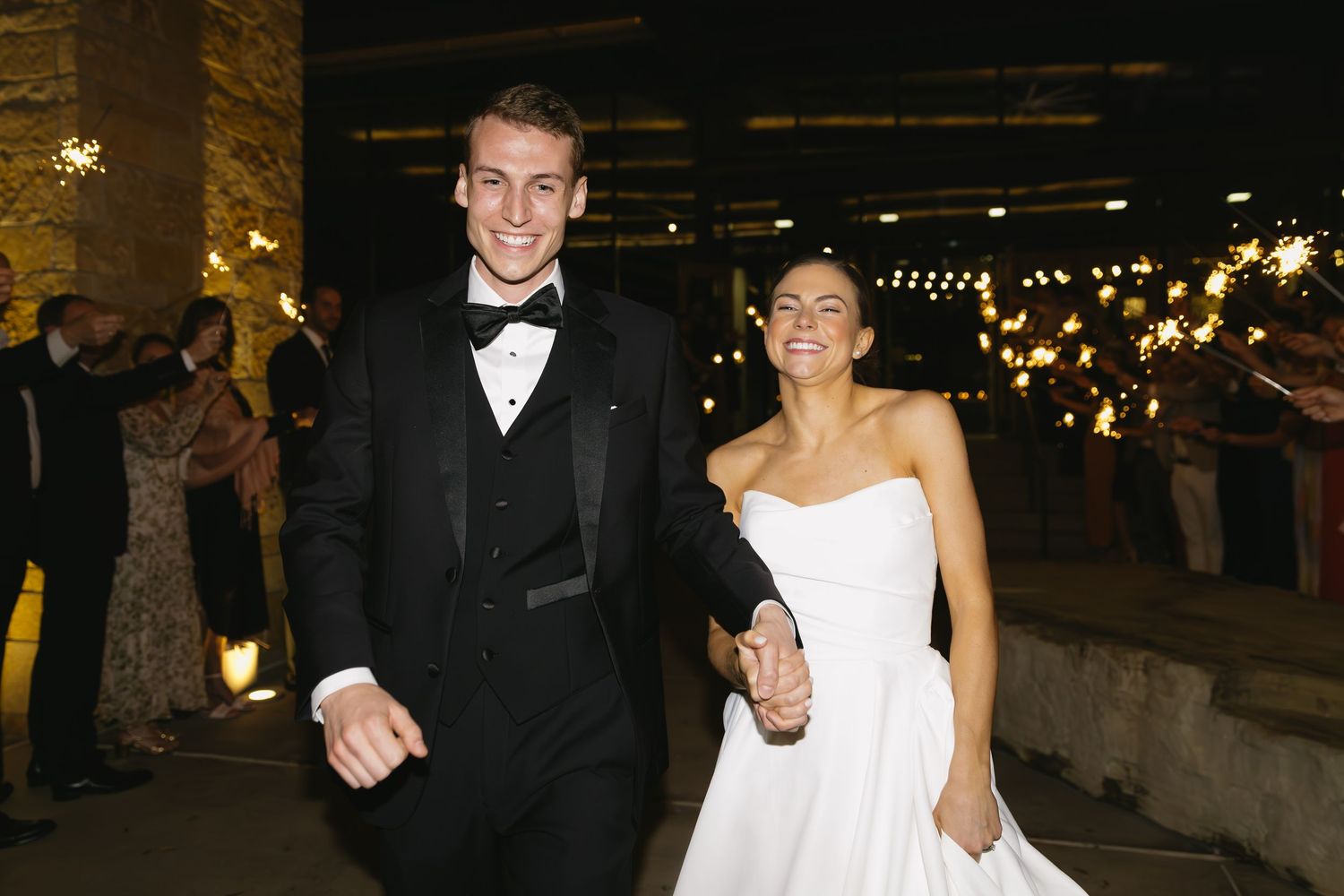 Wedding celebration in an industrial-style venue with warm lighting and exposed brick walls.