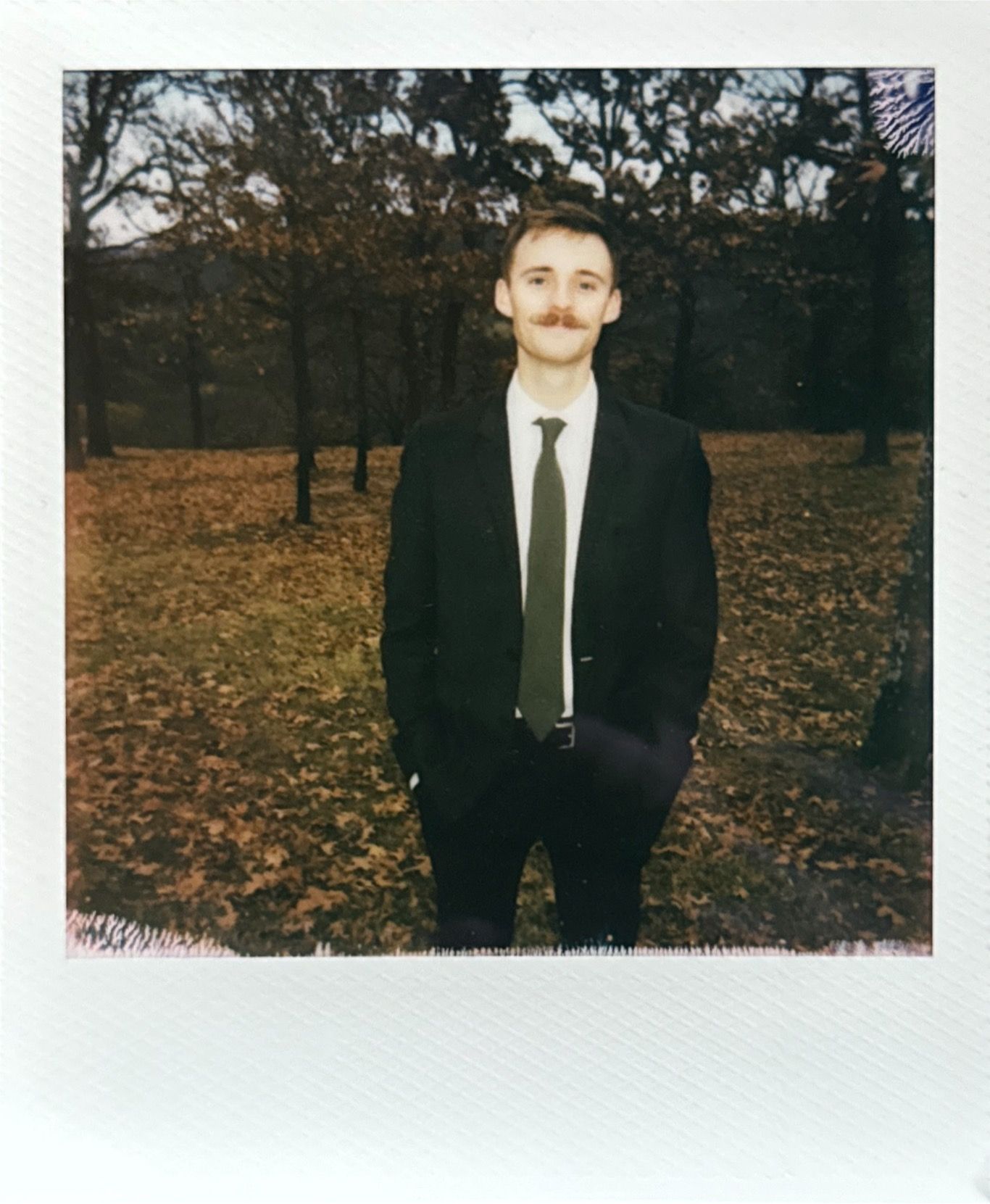 Fall outdoor portrait session with autumn leaves in the background.