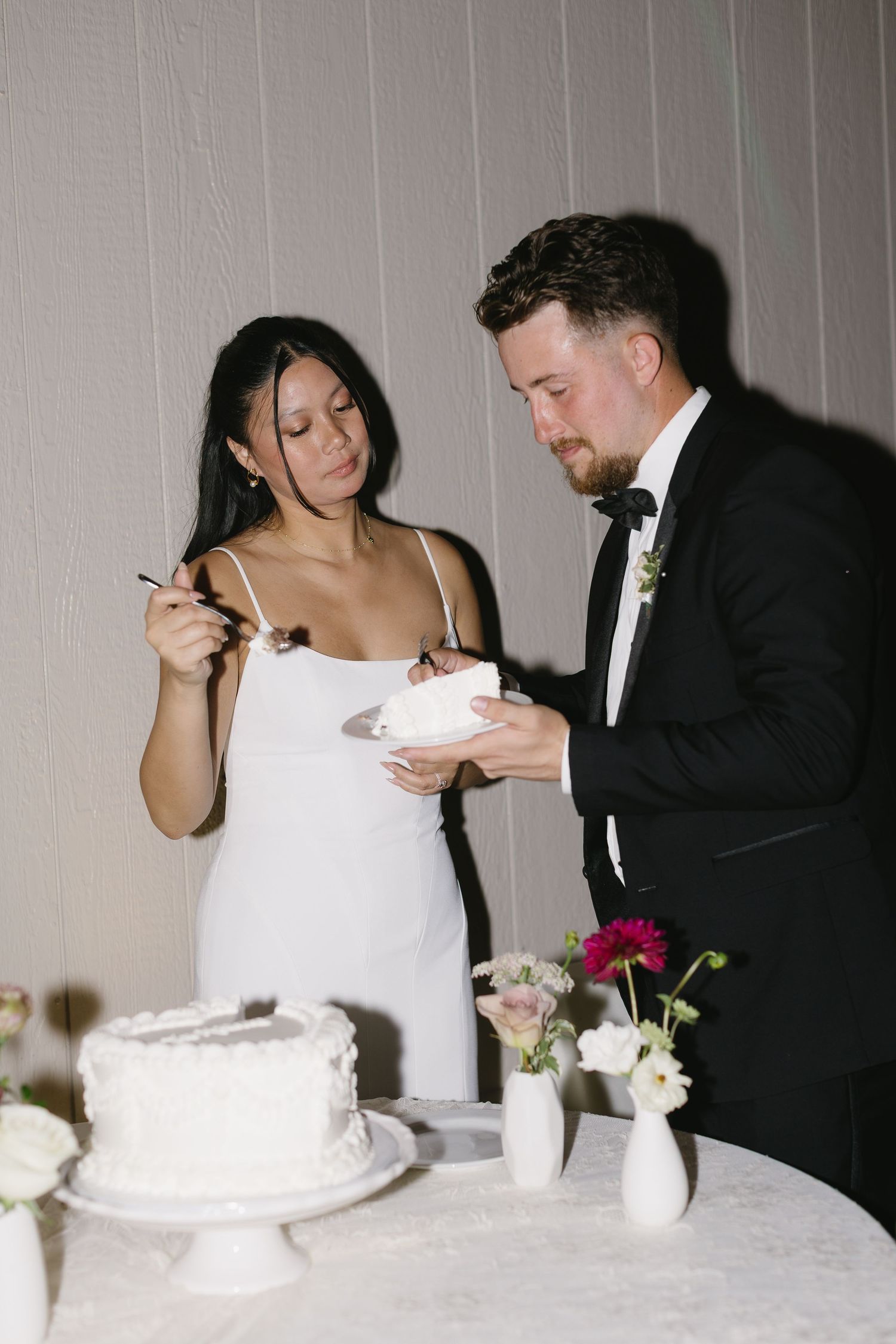 Wedding couple sharing cake cutting moments at their reception.