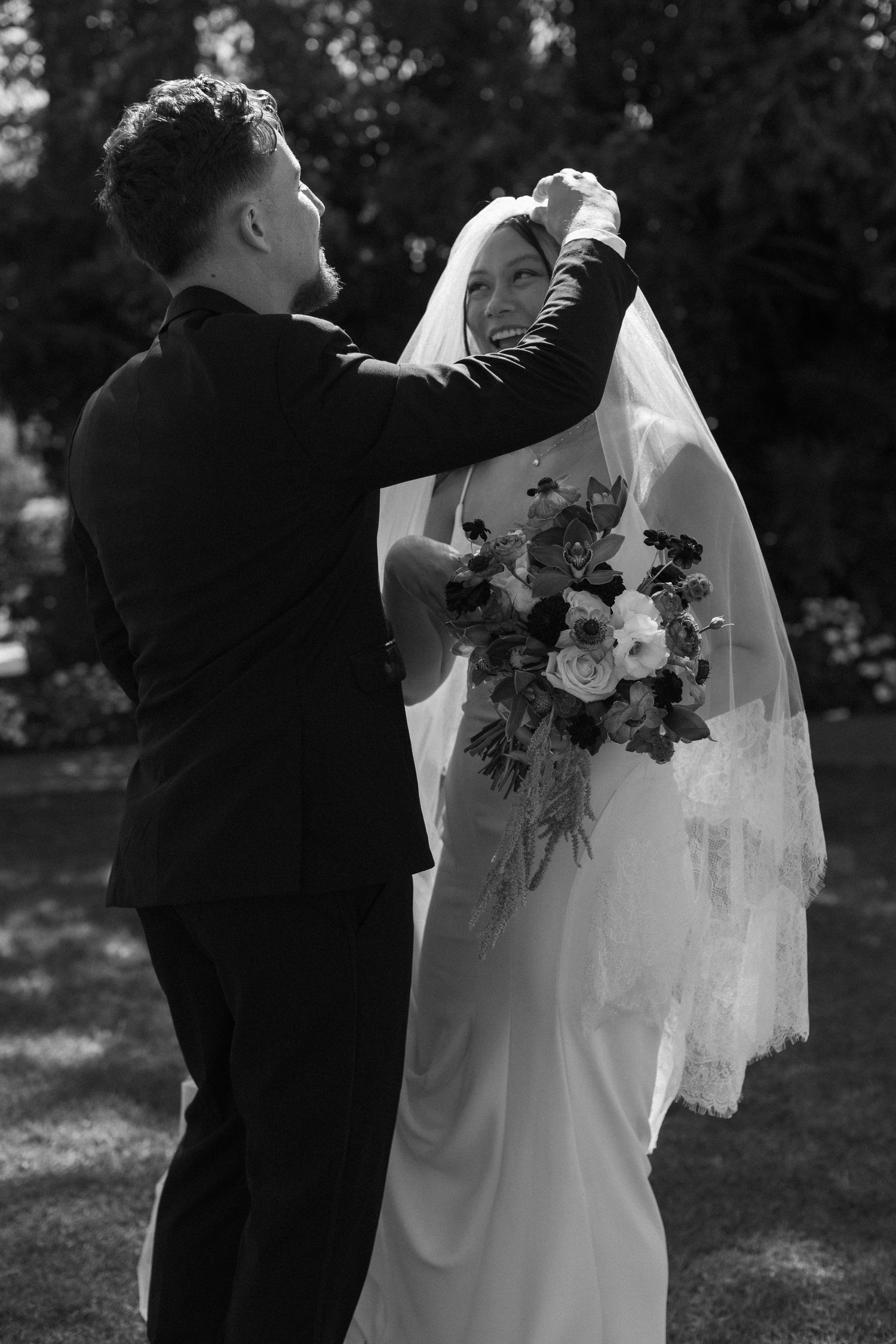 A series of black and white wedding photos showing intimate moments between a bride and groom in an outdoor setting.