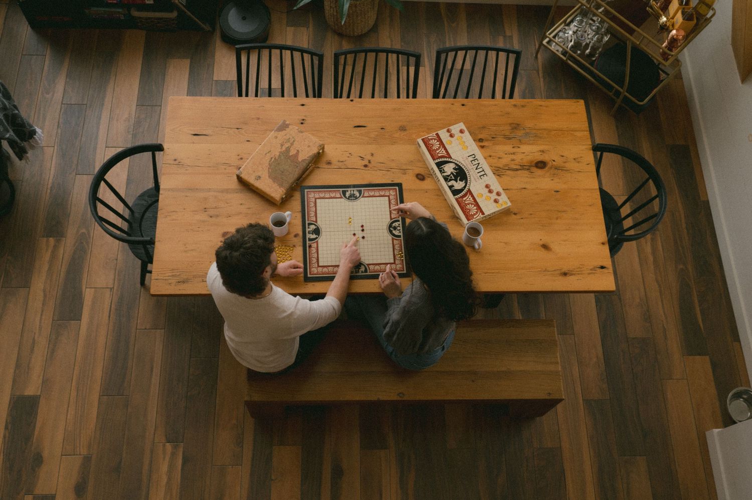 An aerial view of Sidney and her husband, Josh, playing board games in a cozy cabin. Photo taken by Chelsee Taylor Studios.