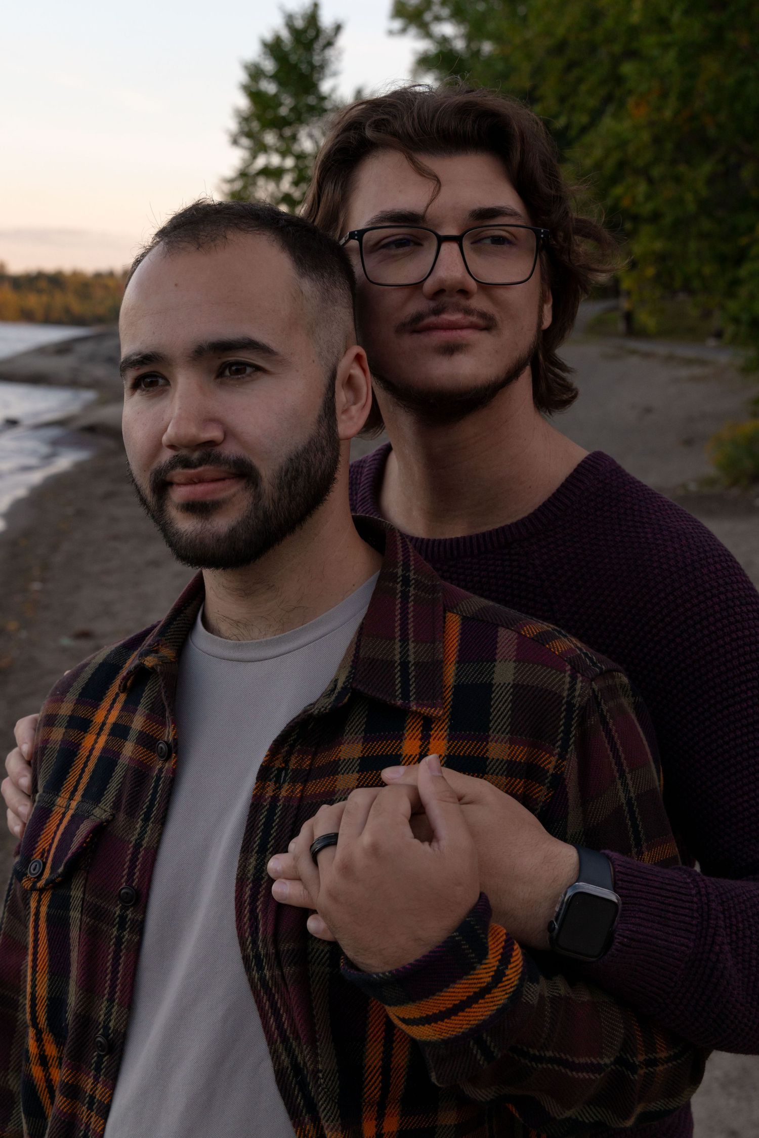 LGBTQ+ Couple's Photography. Engagement photoshoot for two men. Couple standing together, hands held showing off engagement ring.