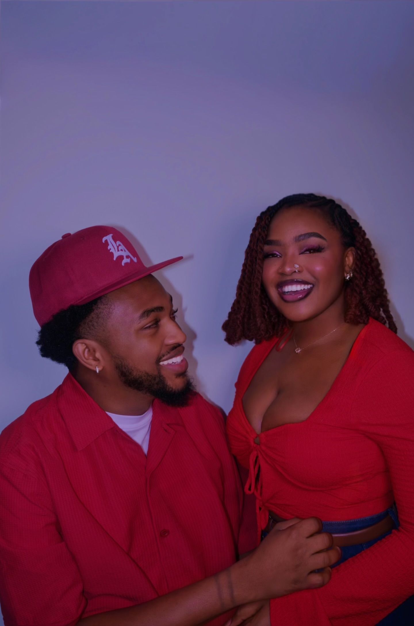 lady in red and man in red smiling