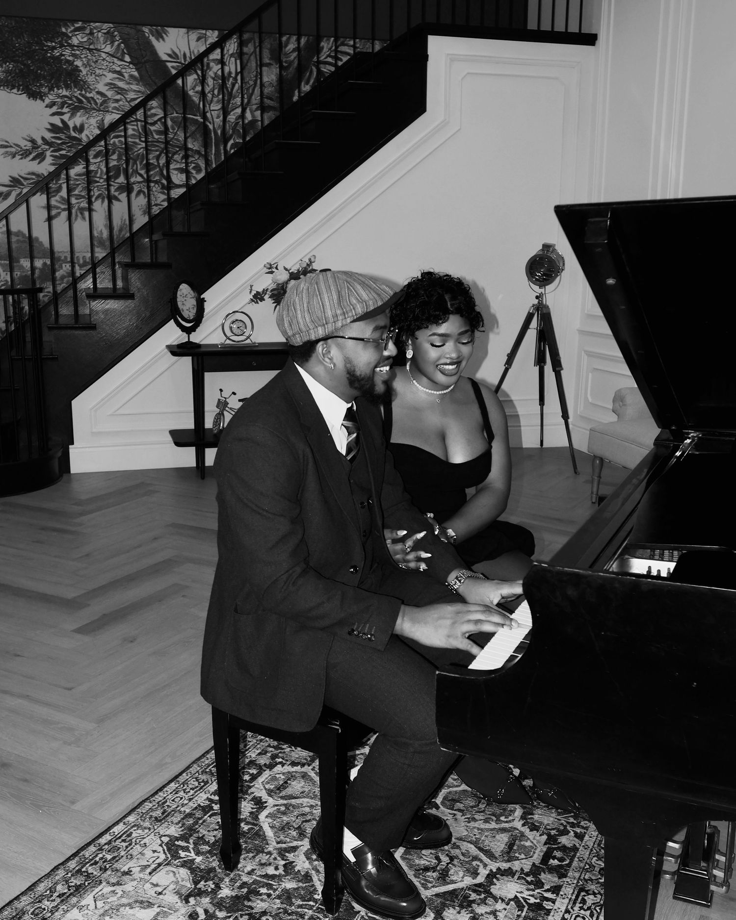 a man playing a piano and a lady listening