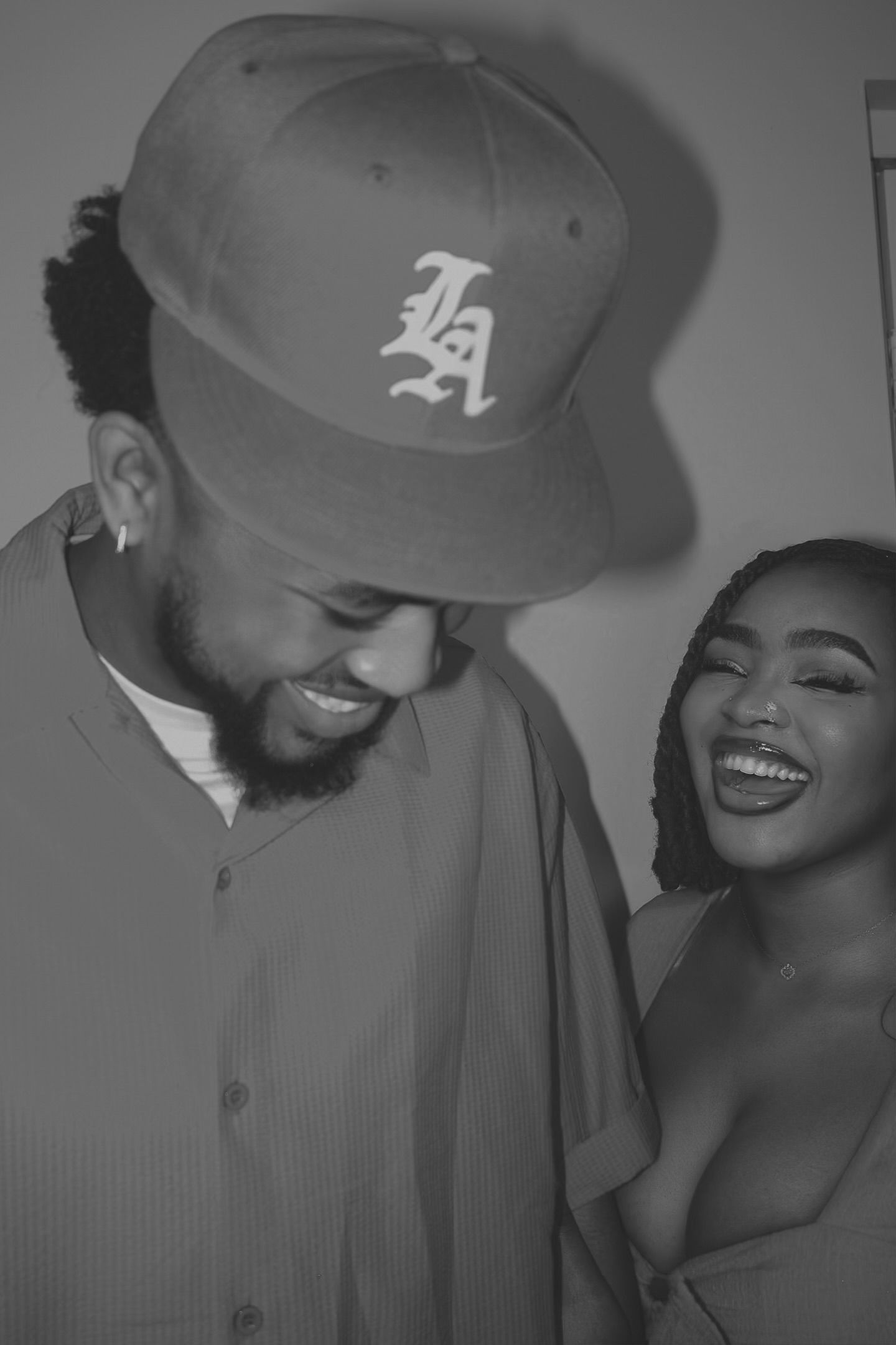 lady smiling with a guy in a hat