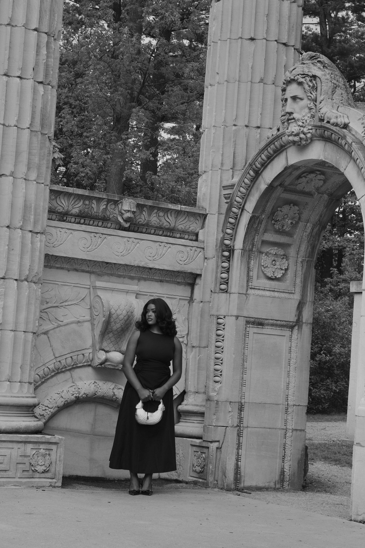 lady standing behind a historical building