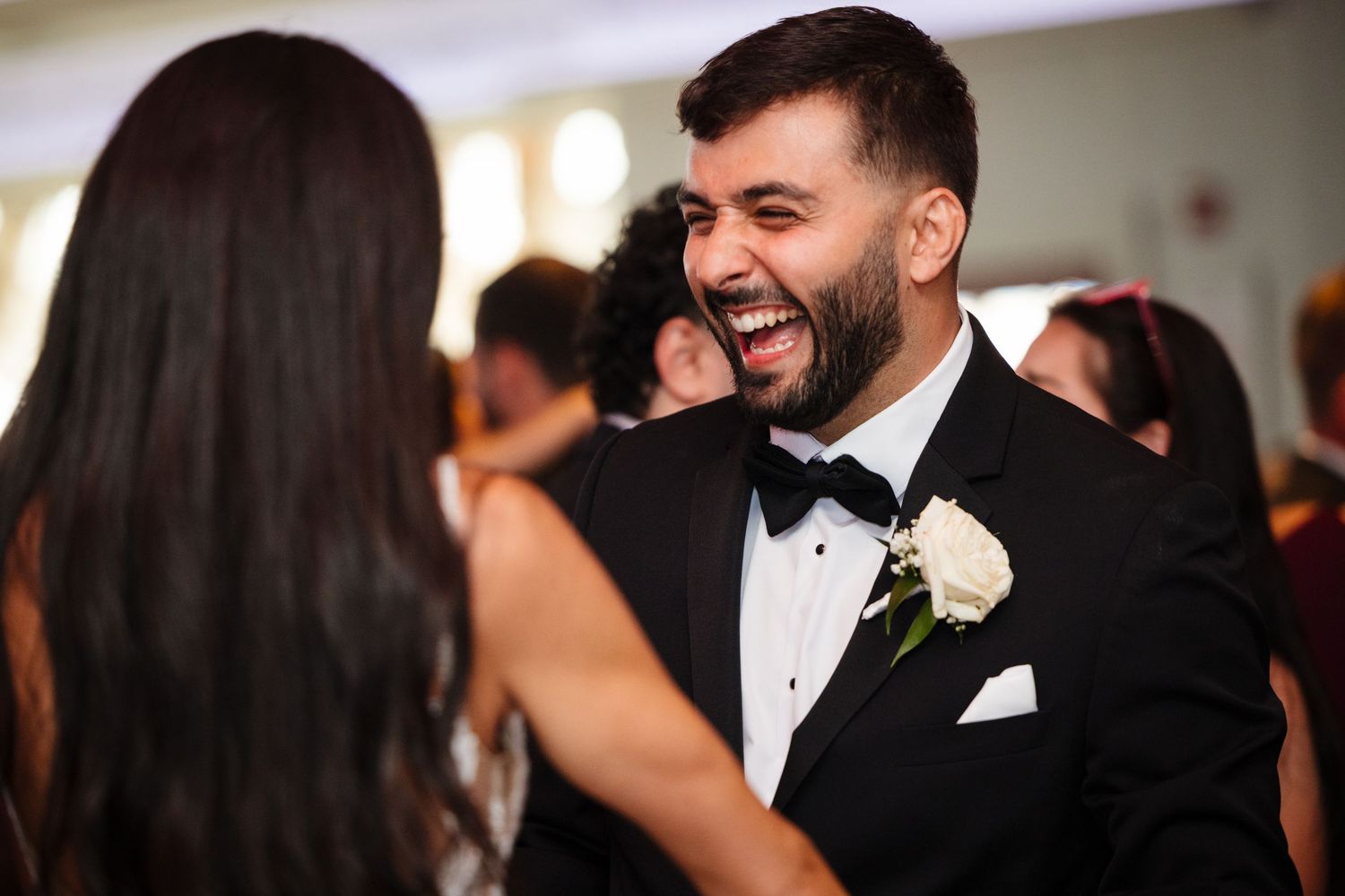 A joyful moment shared between a bride and groom during their wedding reception.