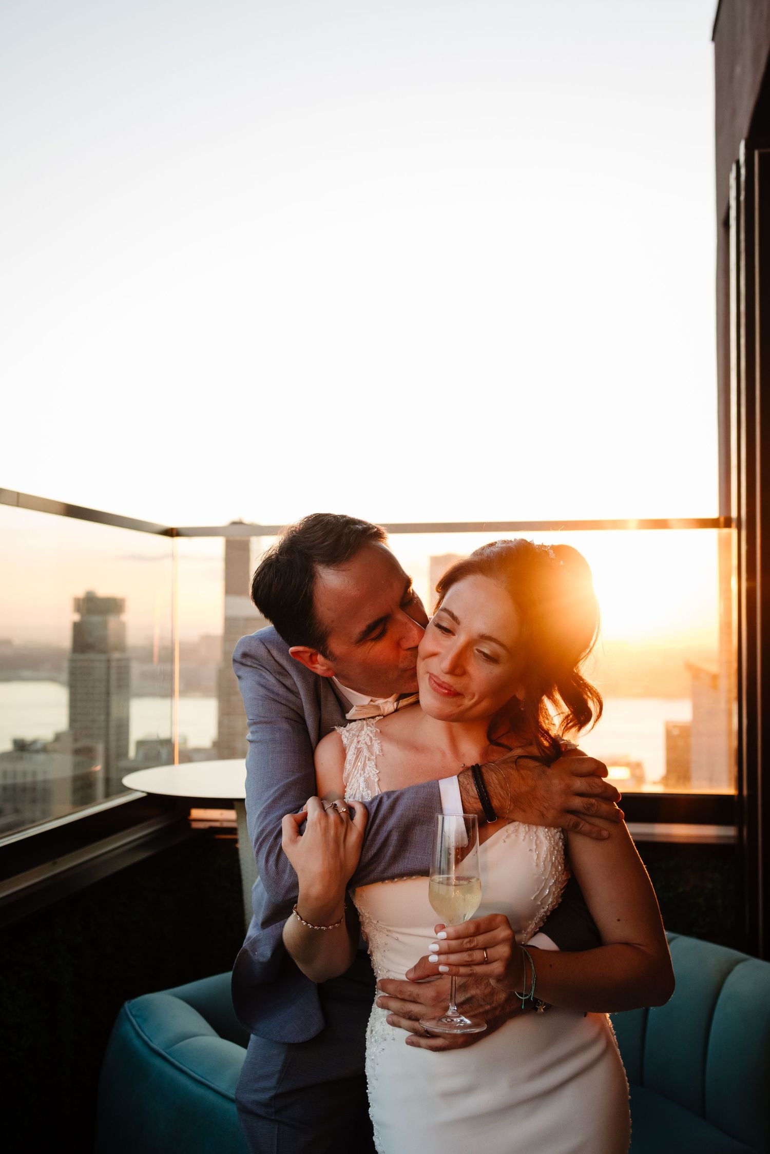 Intimate sunset moment on luxurious rooftop lounge in New York City.