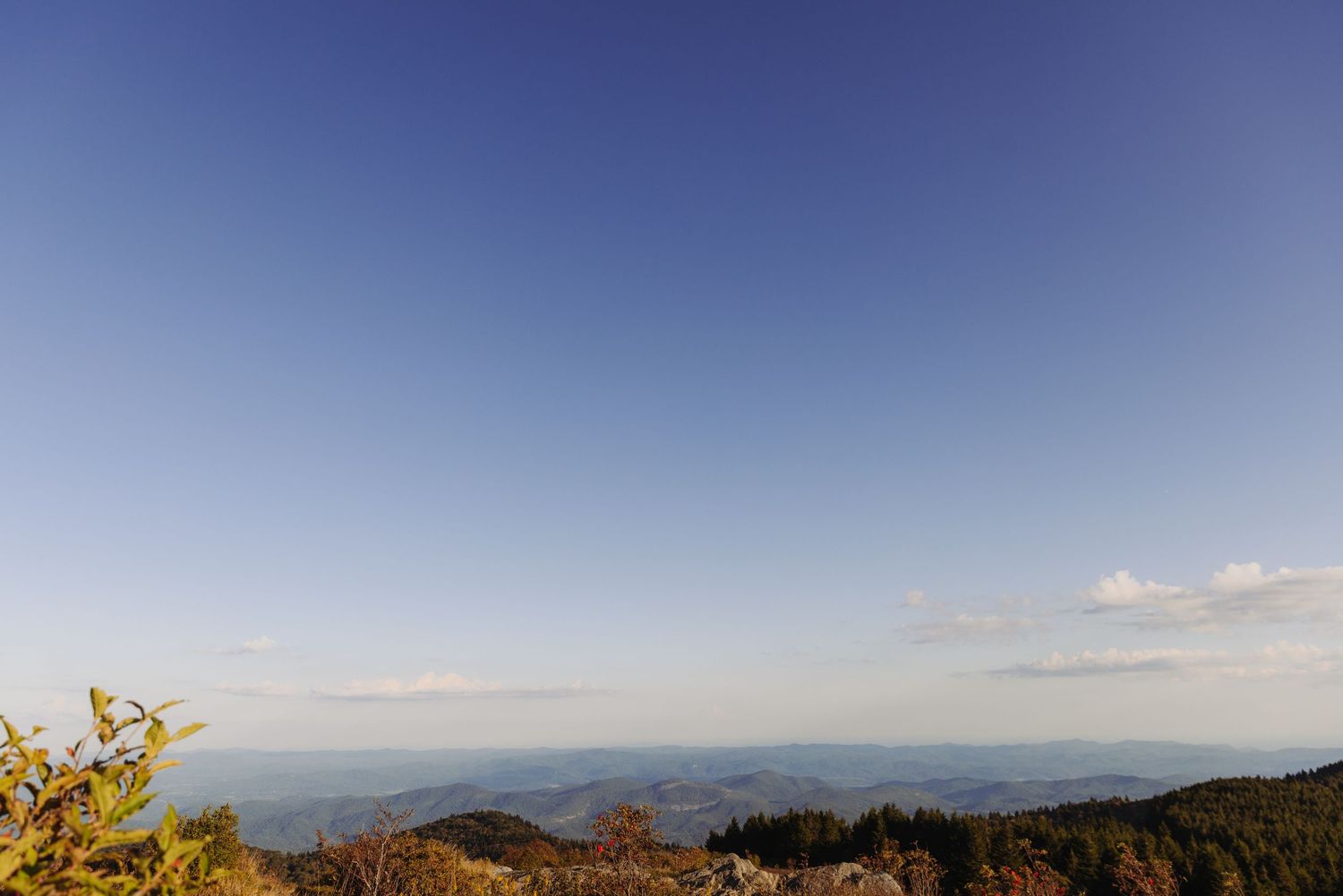 Panoramic mountain vista on a clear day with rolling hills stretching to the horizon.