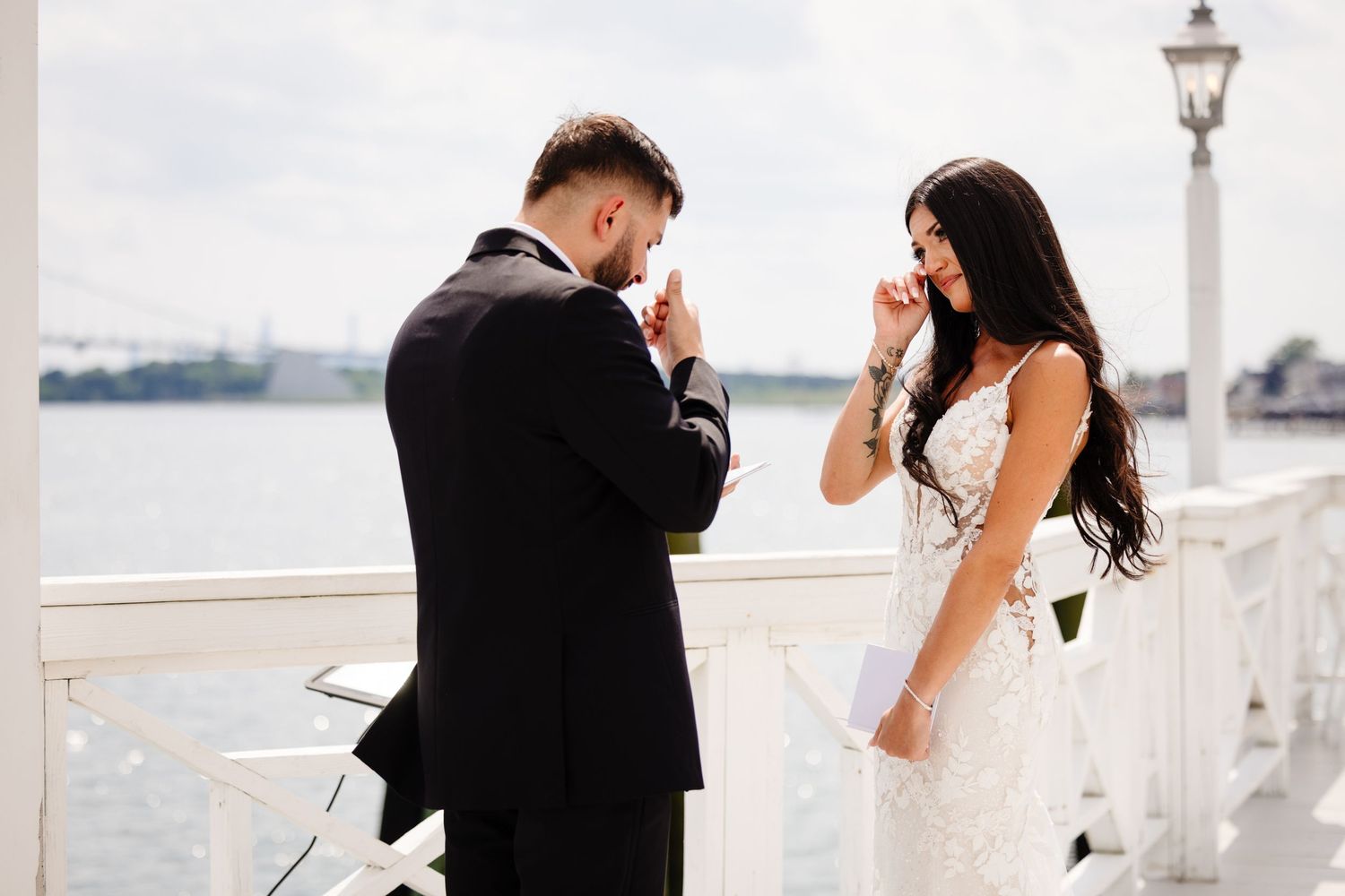 Elegant waterside wedding venue featuring white architectural details and harbor views.