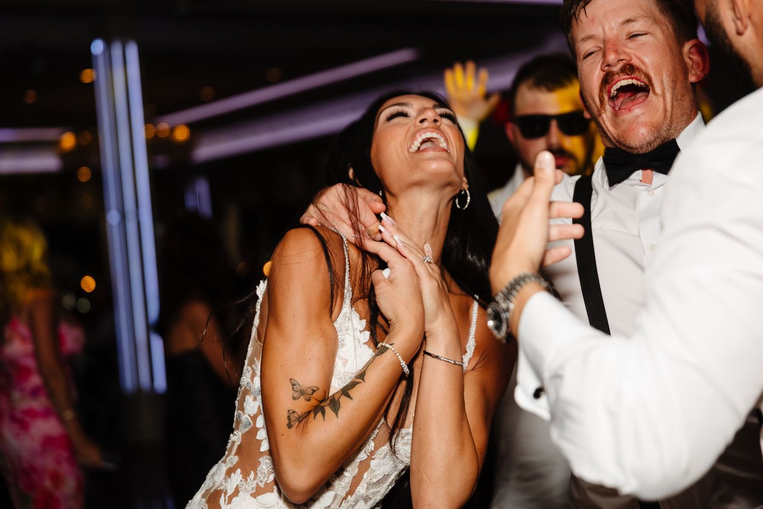 Wedding couple shares a heartfelt laugh during their reception celebration.
