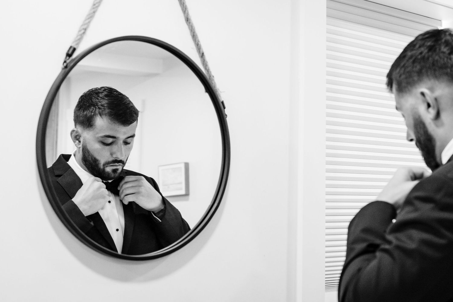 Series of reflections in round mirrors show groomsmen adjusting their ties.