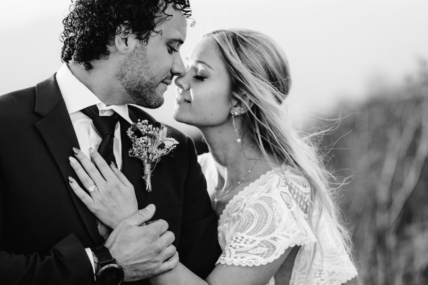 An intimate black and white portrait capturing a tender romantic moment.