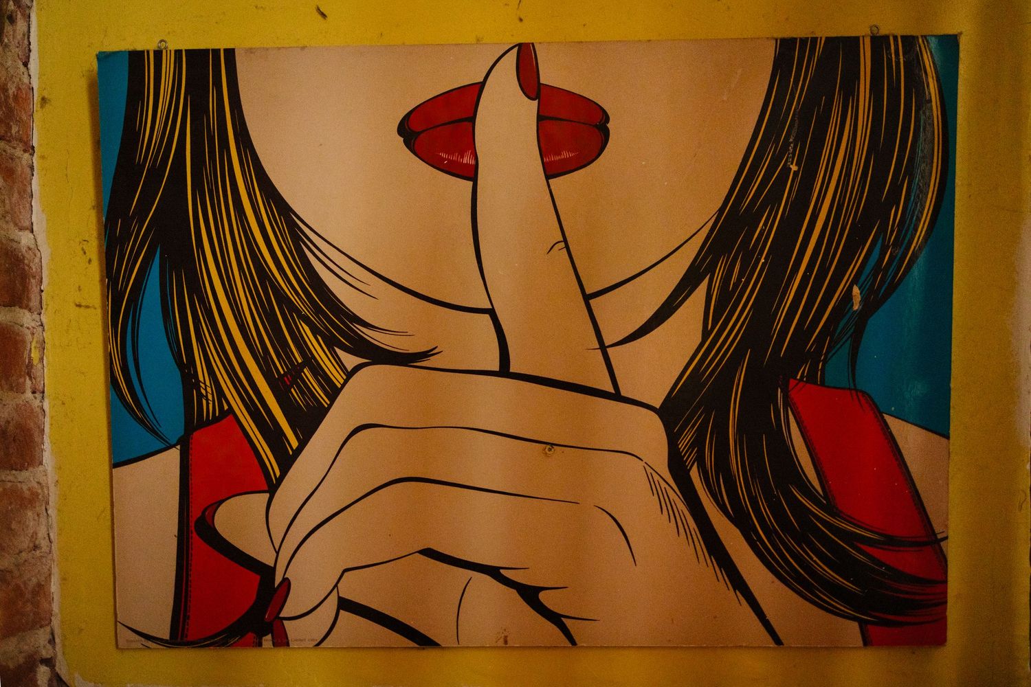 Pop art style wall mural featuring colorful comic book illustrations with red and yellow tones.