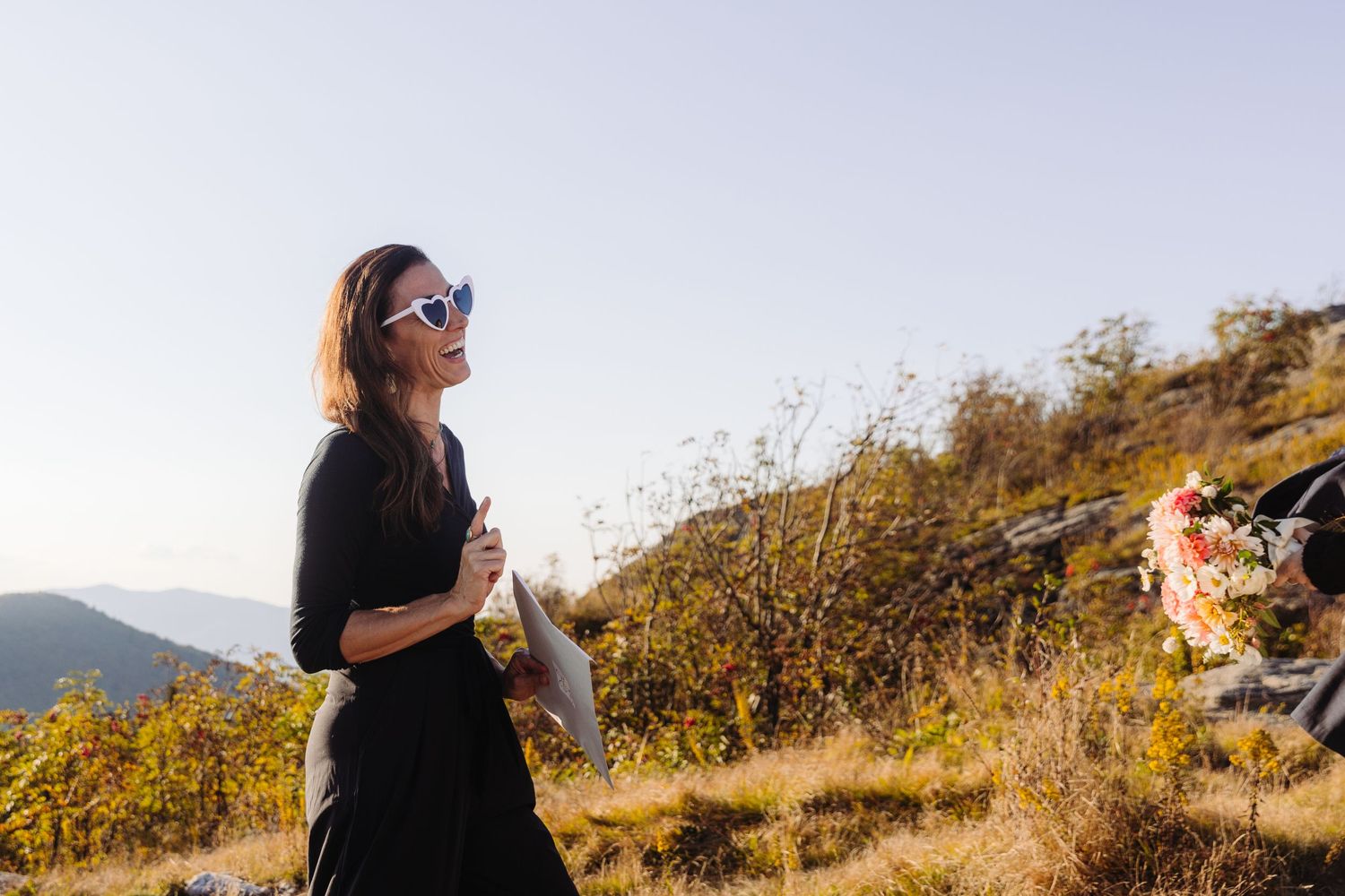 Golden hour wedding photography session on a mountainside trail with autumn foliage.