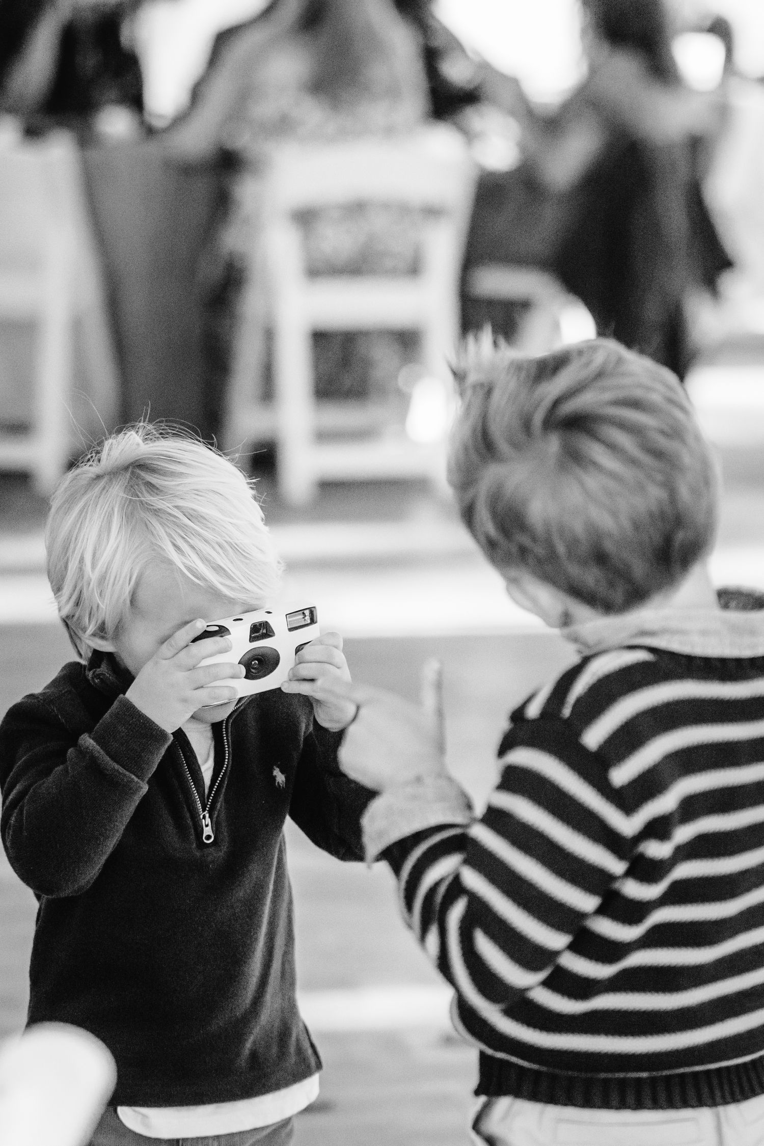 Black and white candid photos of children playing in striped sweaters.