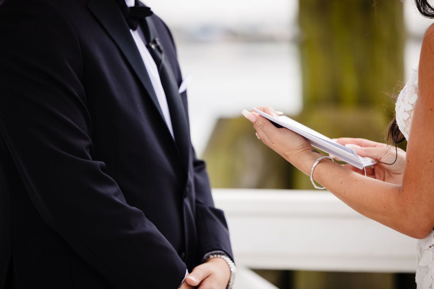 Emotional wedding ceremony moment captured on a bright coastal deck.