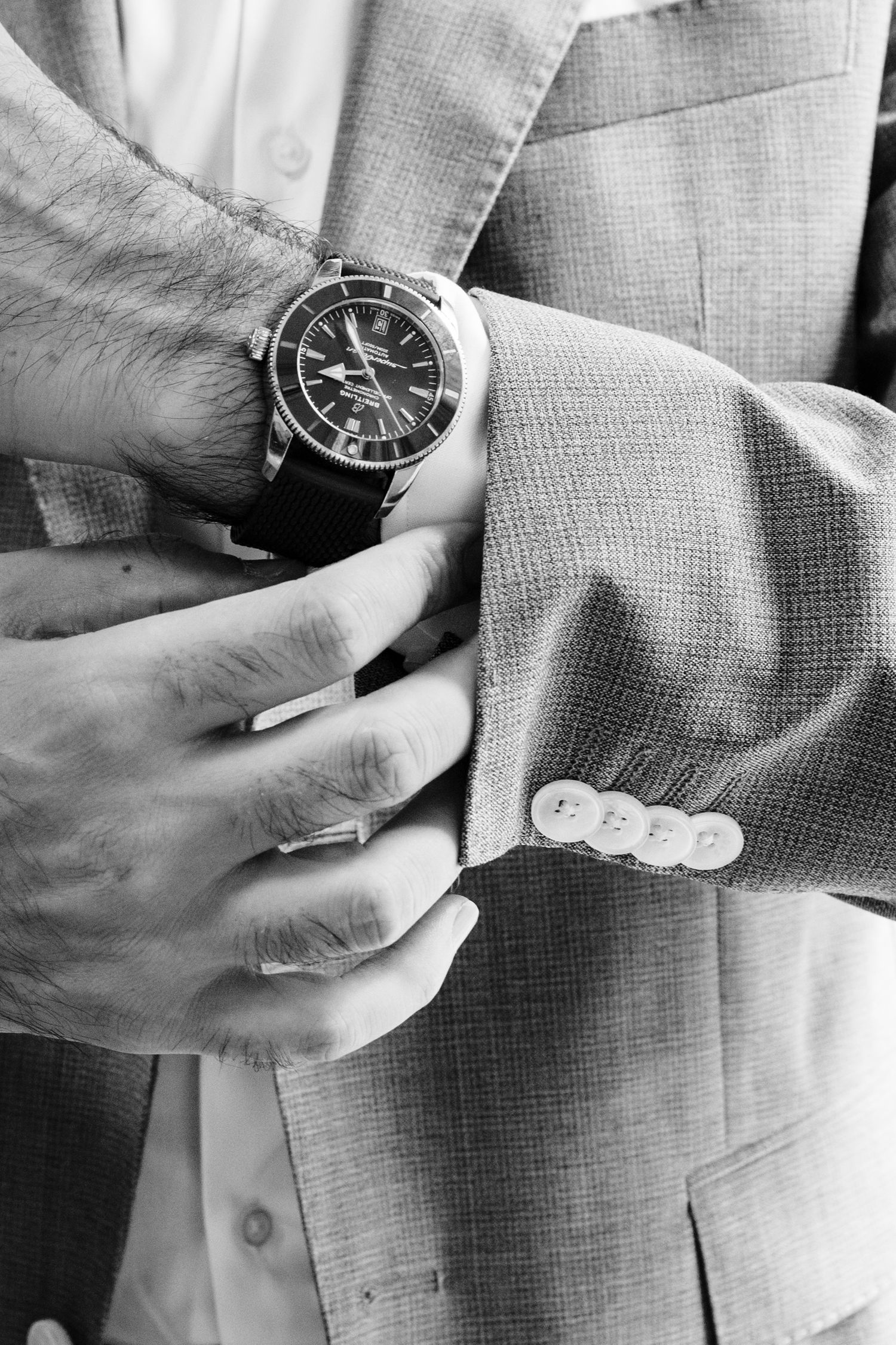 Close-up shots of hands adjusting a classic wristwatch on formal attire.