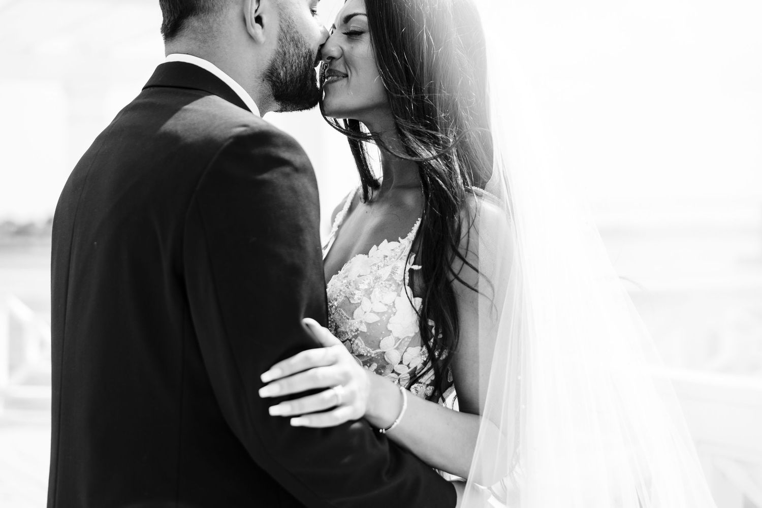 Black and white romantic wedding photo of couple sharing an intimate moment.