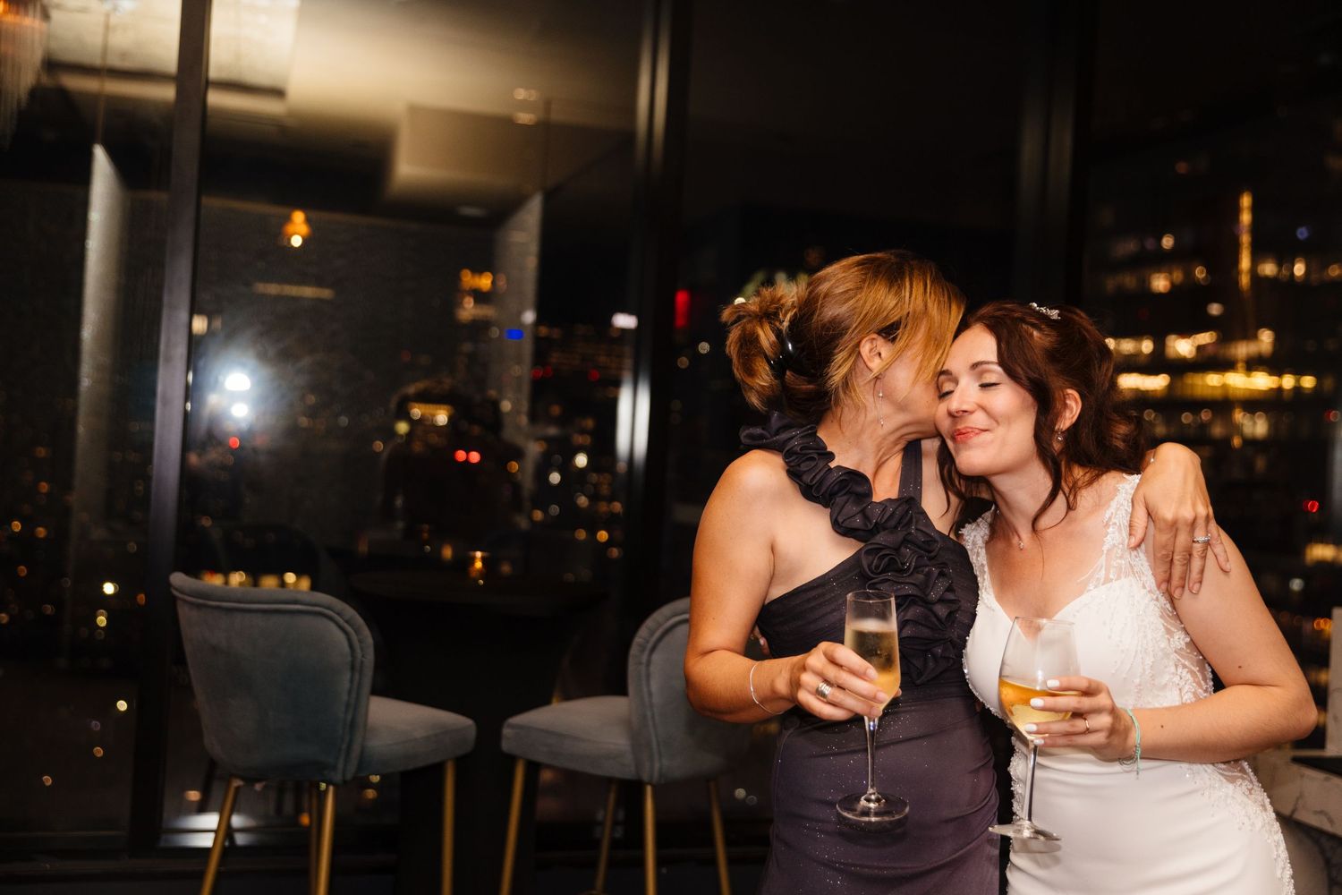 Wedding guests enjoying drinks and conversation at an evening reception.