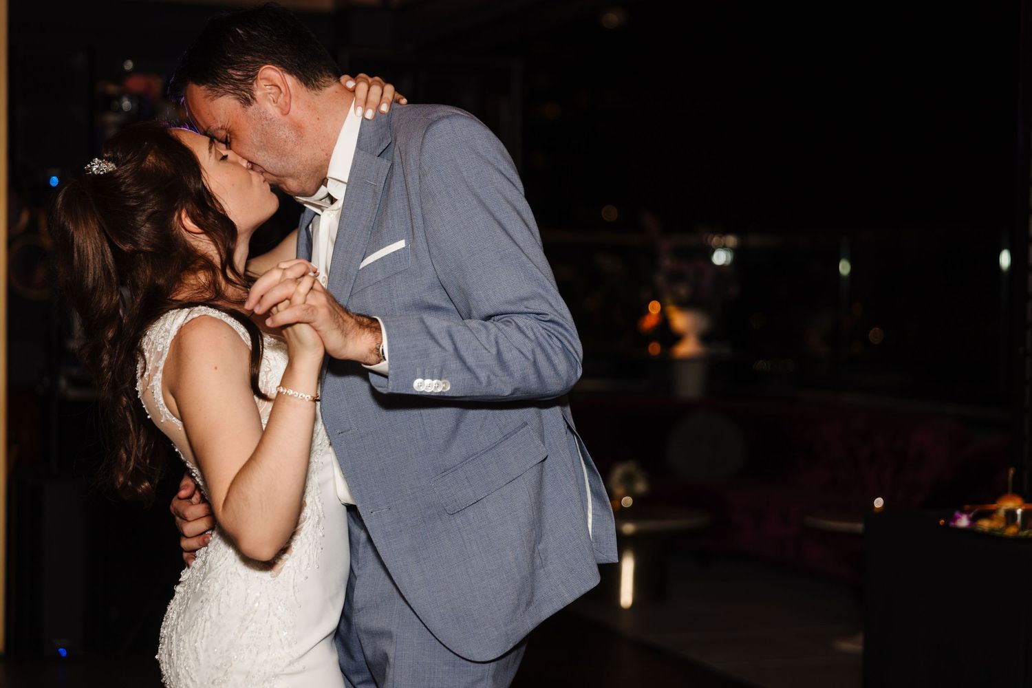 Wedding couple slow dancing together during their evening reception.