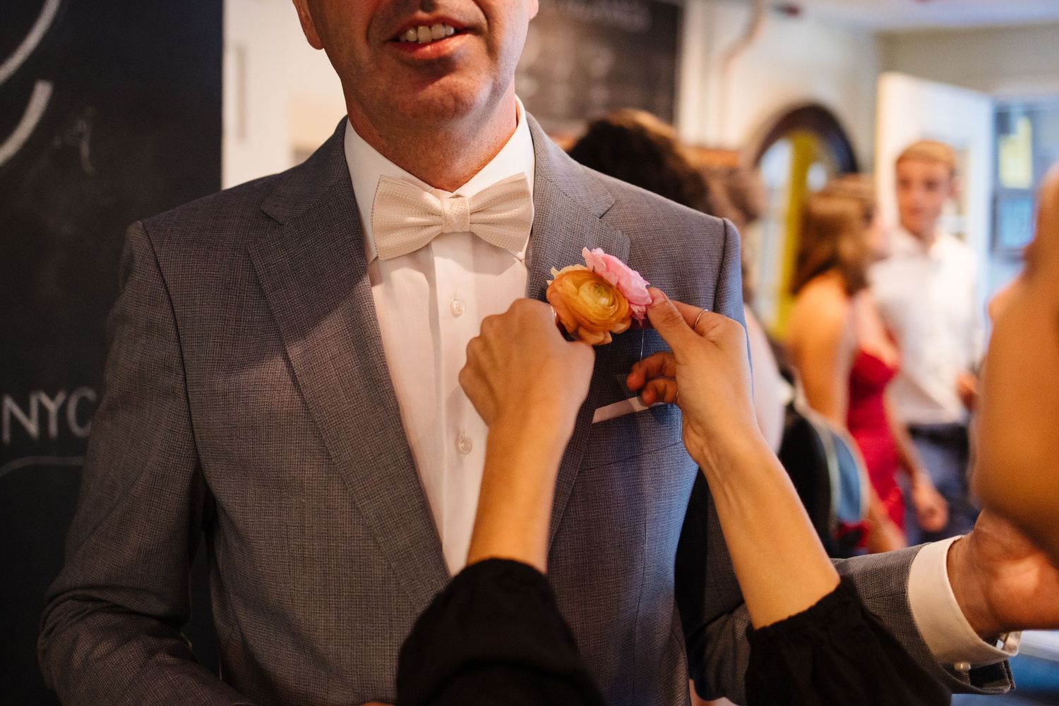 Wedding preparation sequence showing tie and formal wear adjustments.