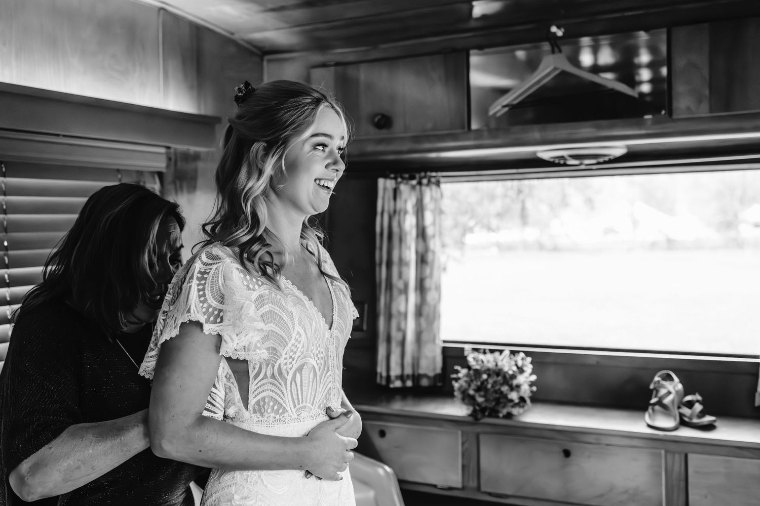 Black and white wedding preparation moments inside vintage vehicle.
