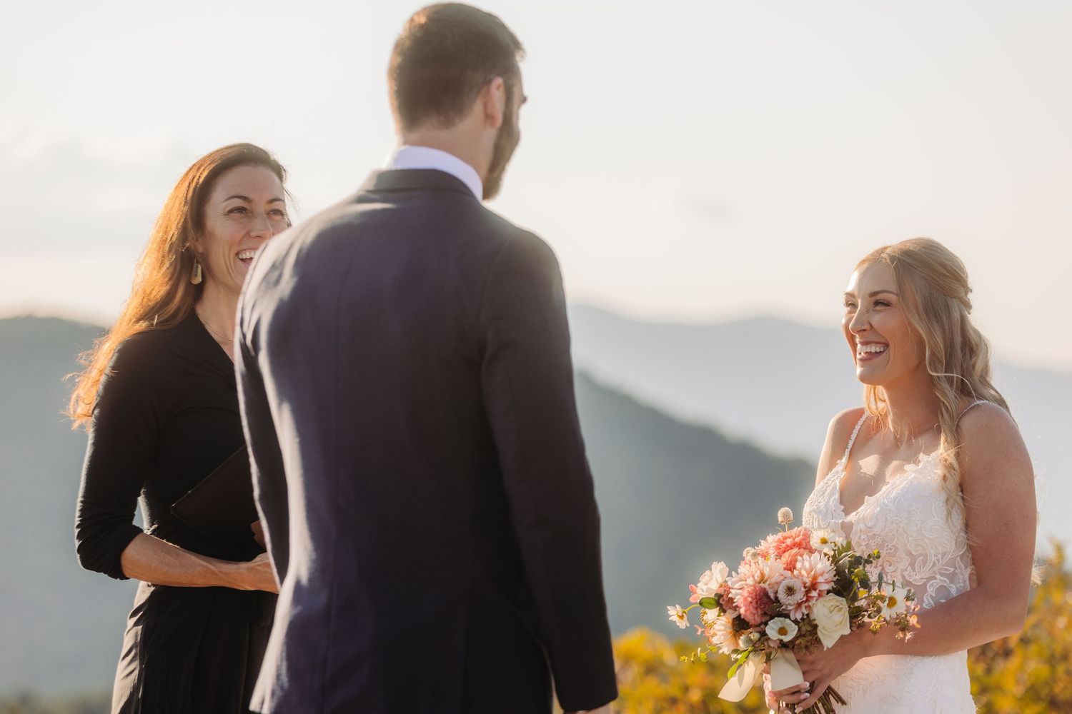 Sunset wedding ceremony with mountain backdrop and warm evening light.