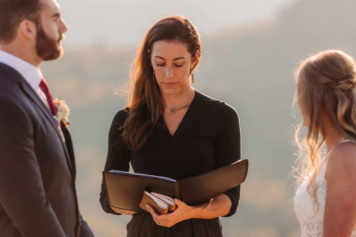 Intimate mountain wedding ceremony captured during golden hour.