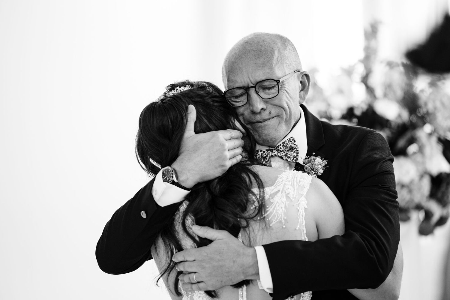An emotional embrace shared during a wedding celebration.