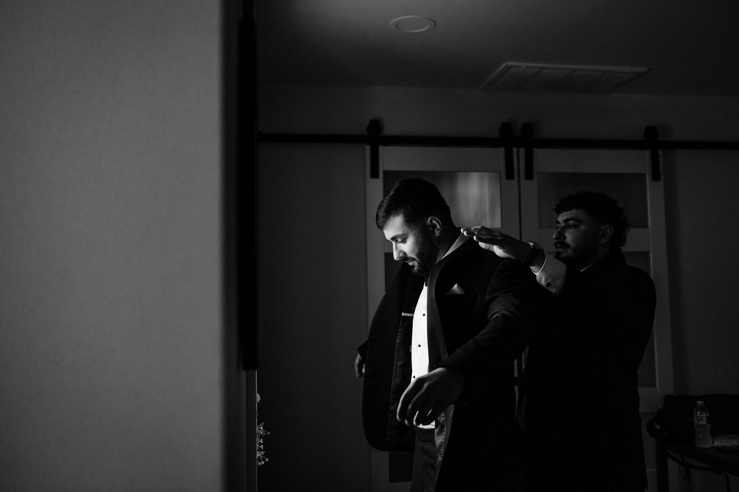 Dramatic shadows in black and white show wedding preparation moments.