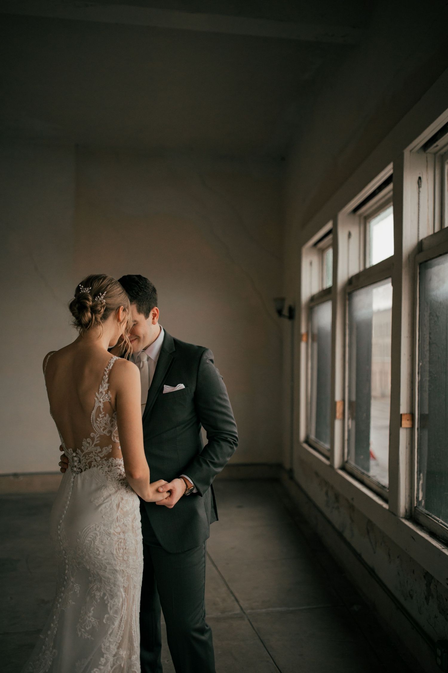 Married couple looking at each other at a wedding venue in Navasota, Texas. She is resting her hand on his chest and they are smiling softly